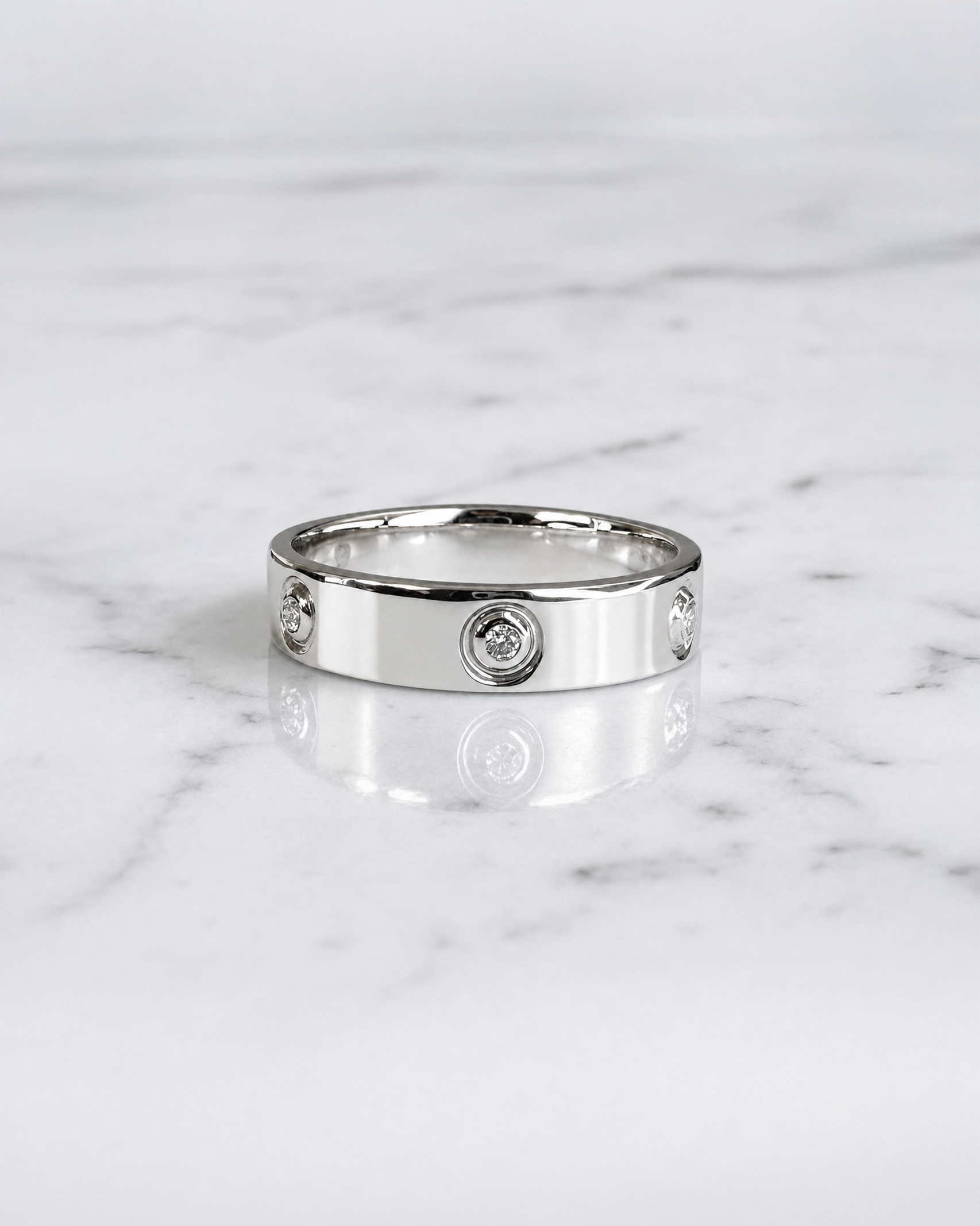 5mm five stone bezel set diamond wedding band with round brilliant diamonds in polished white gold.