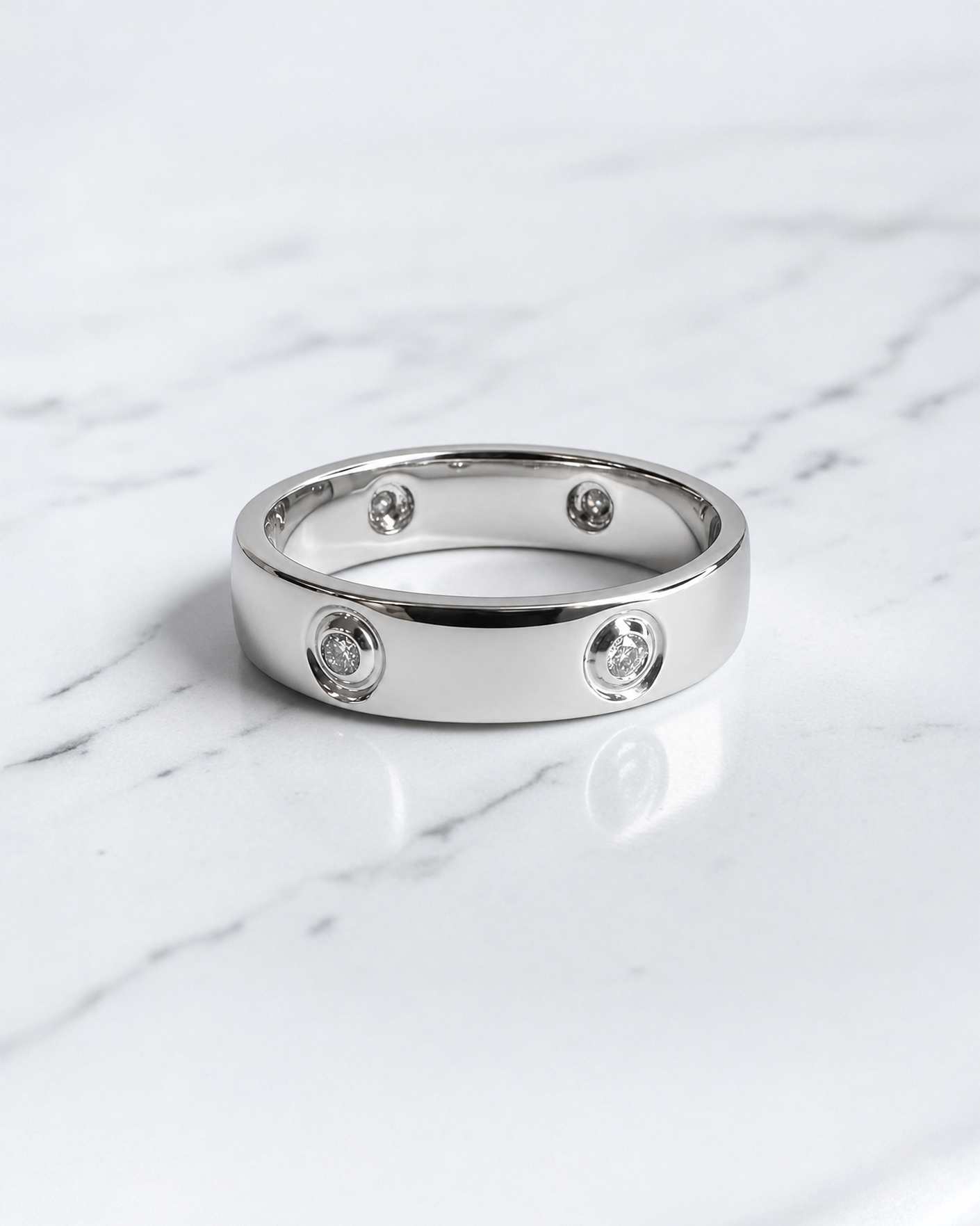 5mm five stone bezel set diamond wedding band with round brilliant diamonds in polished white gold.