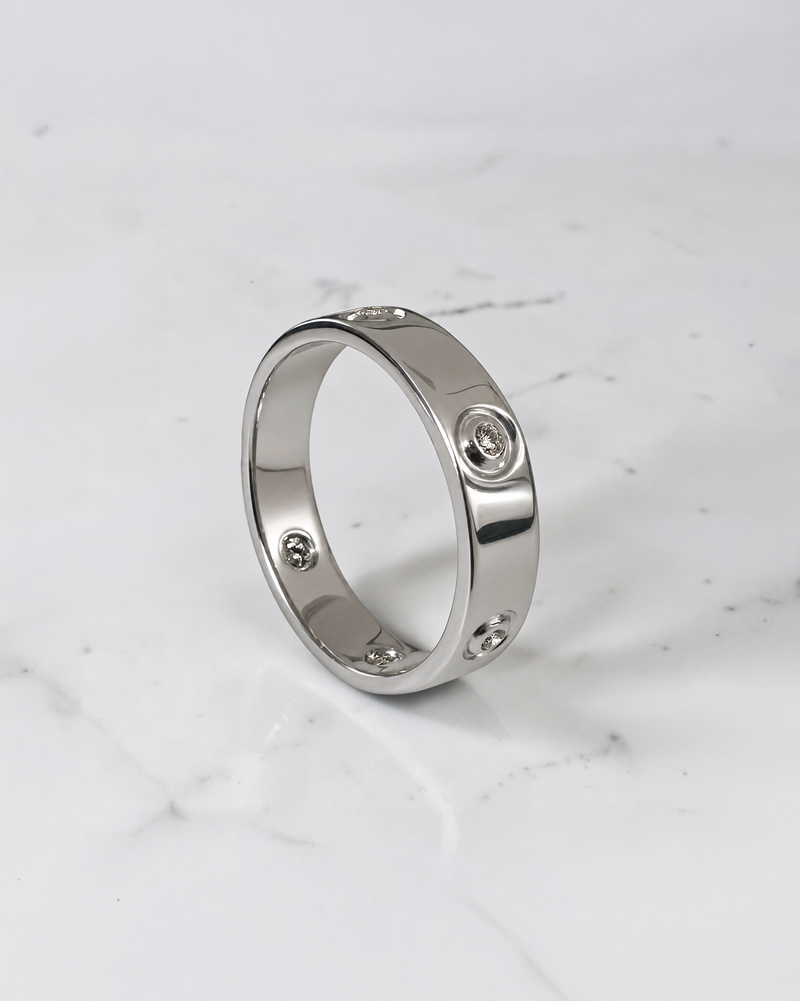 5mm five stone bezel set diamond wedding band with round brilliant diamonds in polished white gold.