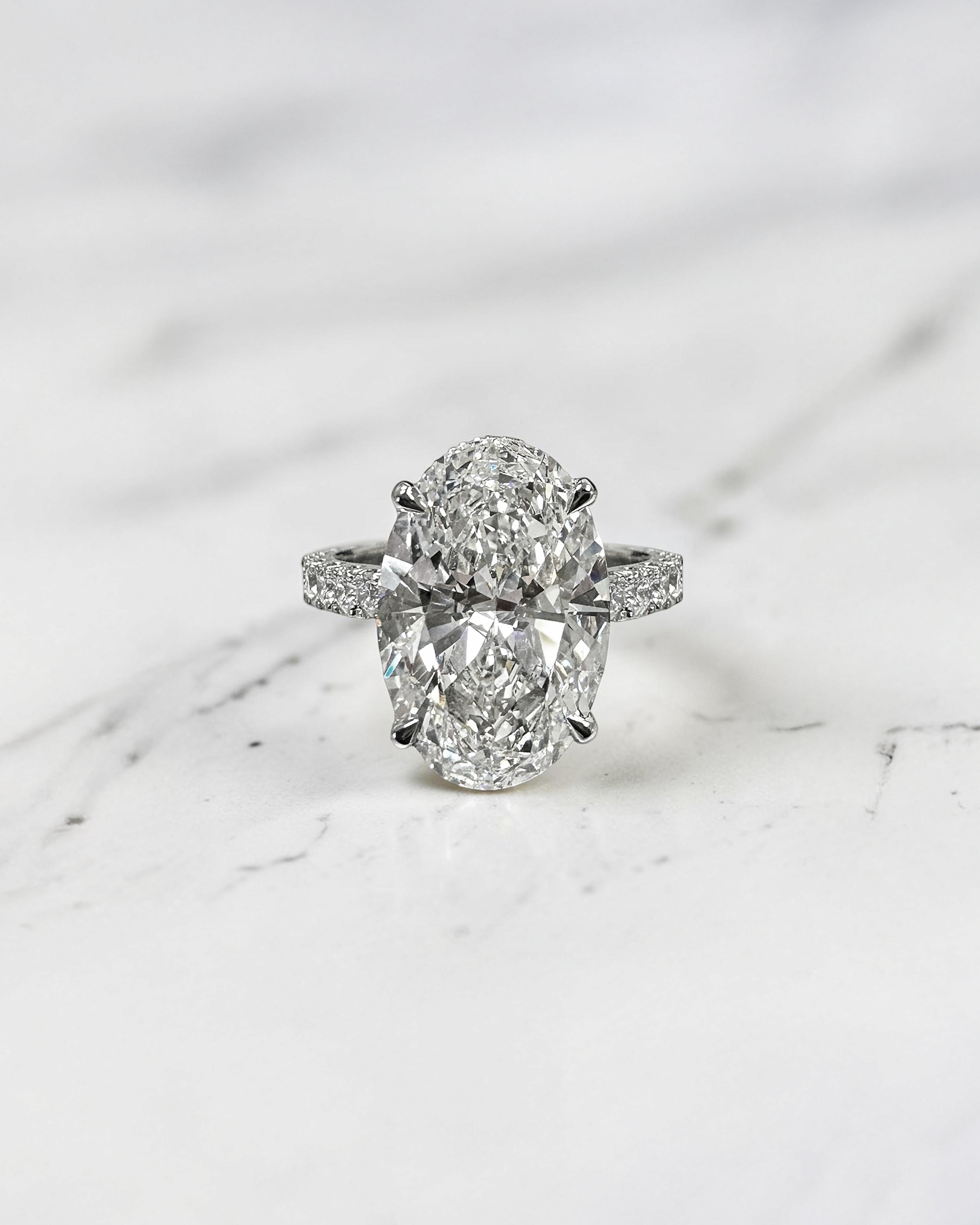6ct oval cut lab grown diamond engagement ring with cathedral setting, diamond shoulder scallop band, diamond wrap hidden halo and diamond bridge. Handmade in London and available in platinum, 18ct yellow gold, white gold or rose gold.