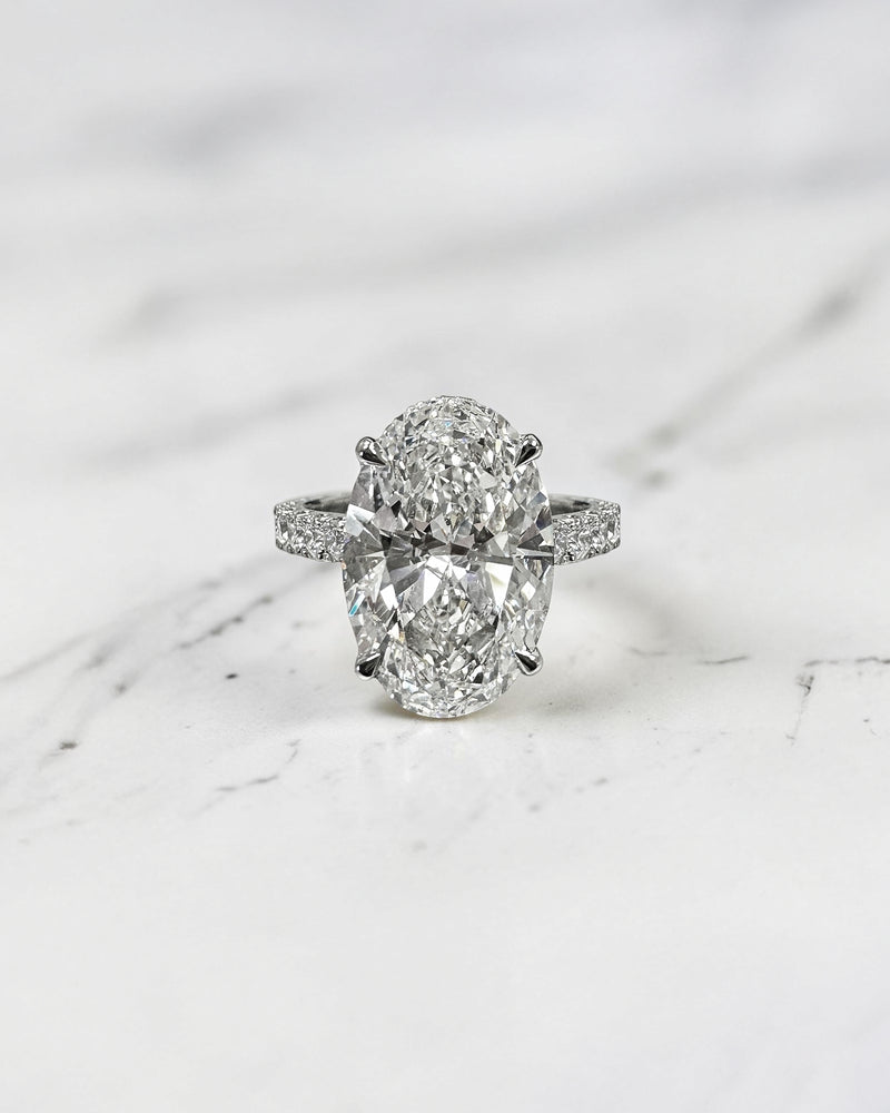 Cathedral Setting Ring Featuring a 6ct Oval Cut Lab Grown Diamond shoulder scallop band, diamond wrap, hidden halo, and diamond bridge. Handmade in London and available in platinum, 18ct yellow gold, white gold or rose gold.