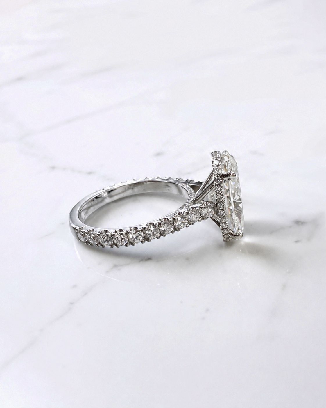 6ct oval cut lab grown diamond engagement ring with cathedral setting, diamond shoulder scallop band, diamond wrap hidden halo and diamond bridge. Handmade in London and available in platinum, 18ct yellow gold, white gold or rose gold.
