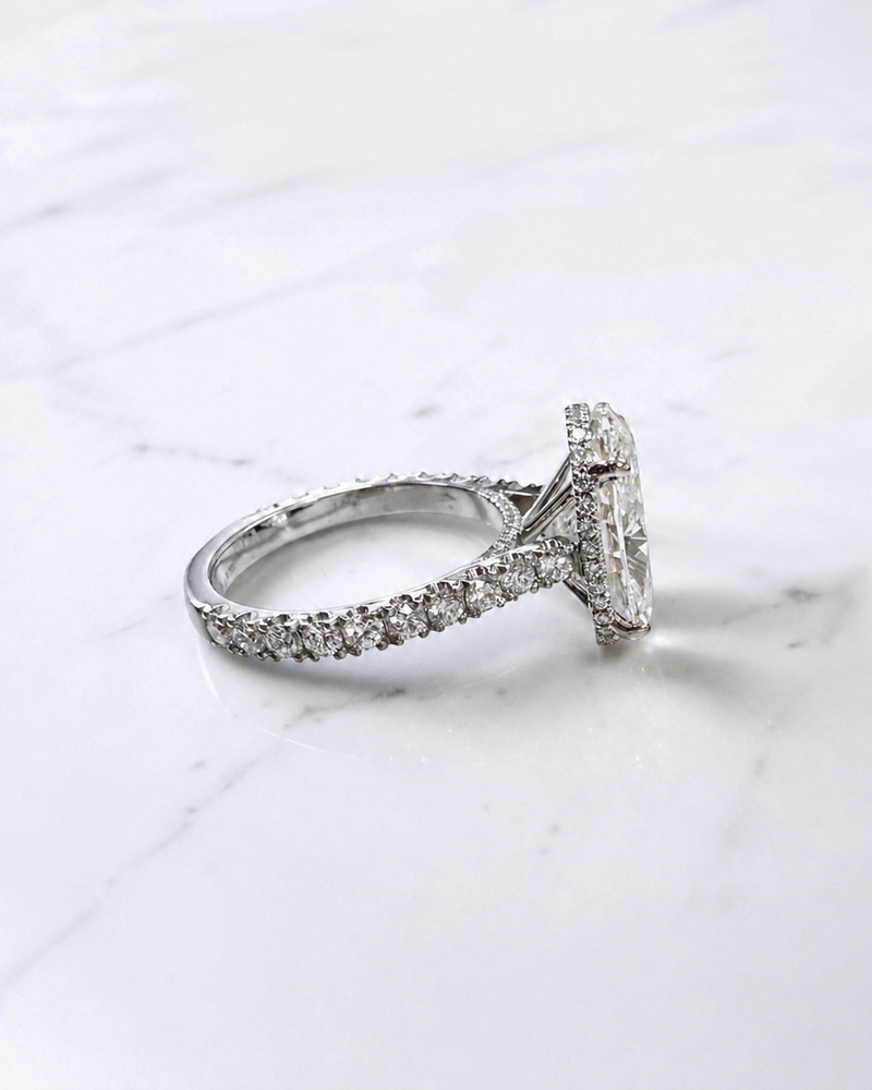 6ct oval cut lab grown diamond engagement ring with cathedral setting, diamond shoulder scallop band, diamond wrap hidden halo and diamond bridge. Handmade in London and available in platinum, 18ct yellow gold, white gold or rose gold.
