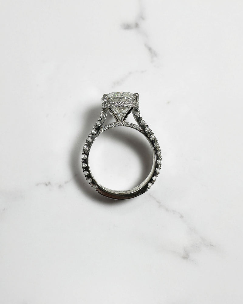 6ct oval cut lab grown diamond engagement ring with cathedral setting, diamond shoulder scallop band, diamond wrap hidden halo and diamond bridge. Handmade in London and available in platinum, 18ct yellow gold, white gold or rose gold.
