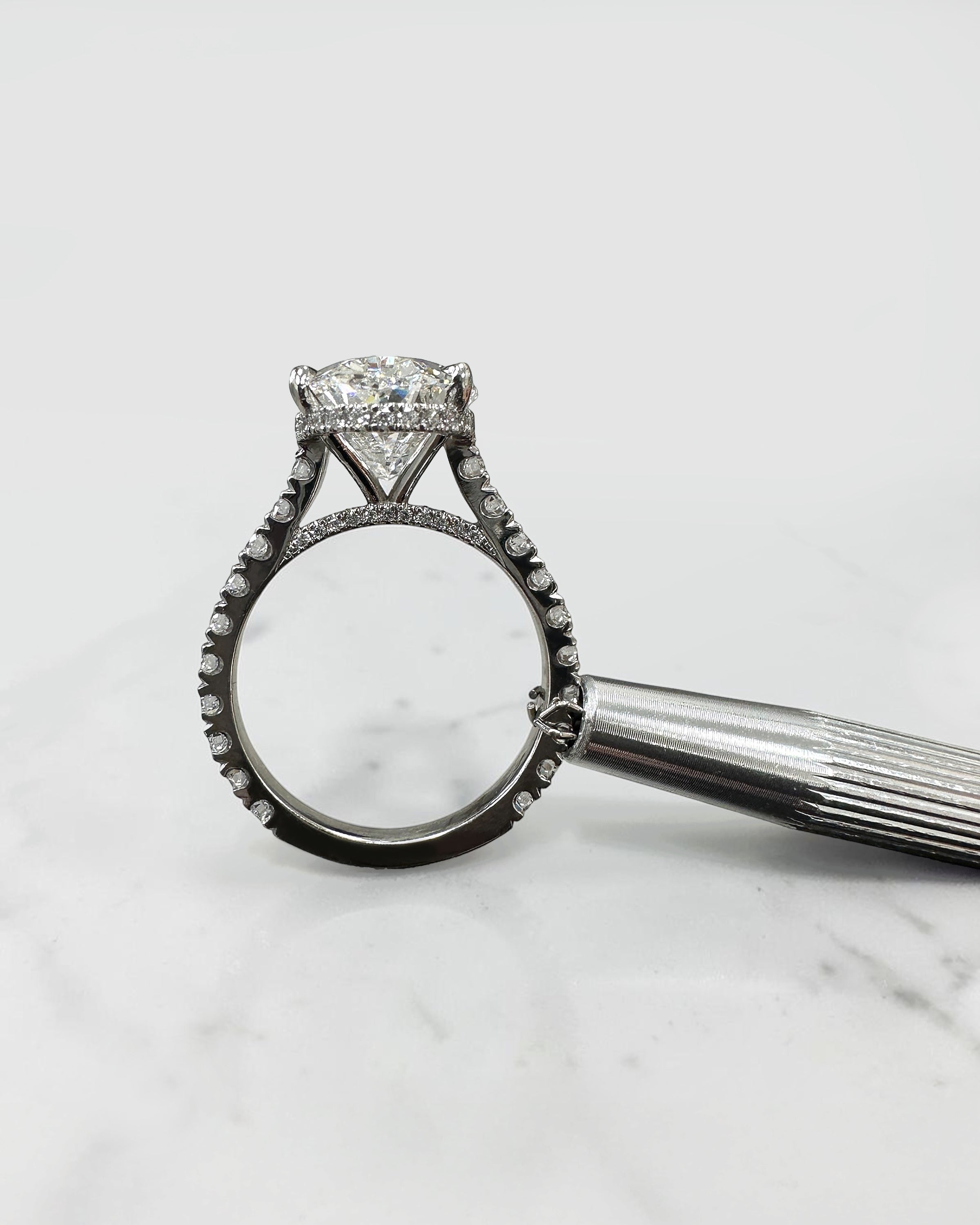 6ct oval cut lab grown diamond engagement ring with cathedral setting, diamond shoulder scallop band, diamond wrap hidden halo and diamond bridge. Handmade in London and available in platinum, 18ct yellow gold, white gold or rose gold.
