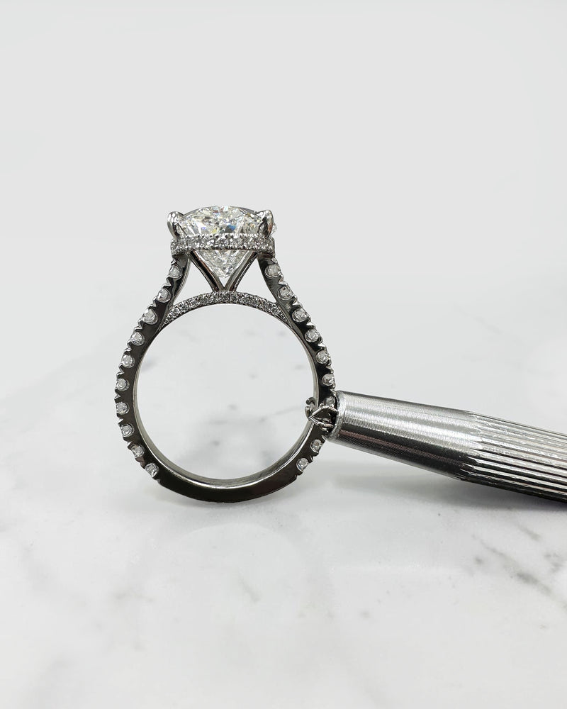 6ct oval cut lab grown diamond engagement ring with cathedral setting, diamond shoulder scallop band, diamond wrap hidden halo and diamond bridge. Handmade in London and available in platinum, 18ct yellow gold, white gold or rose gold.
