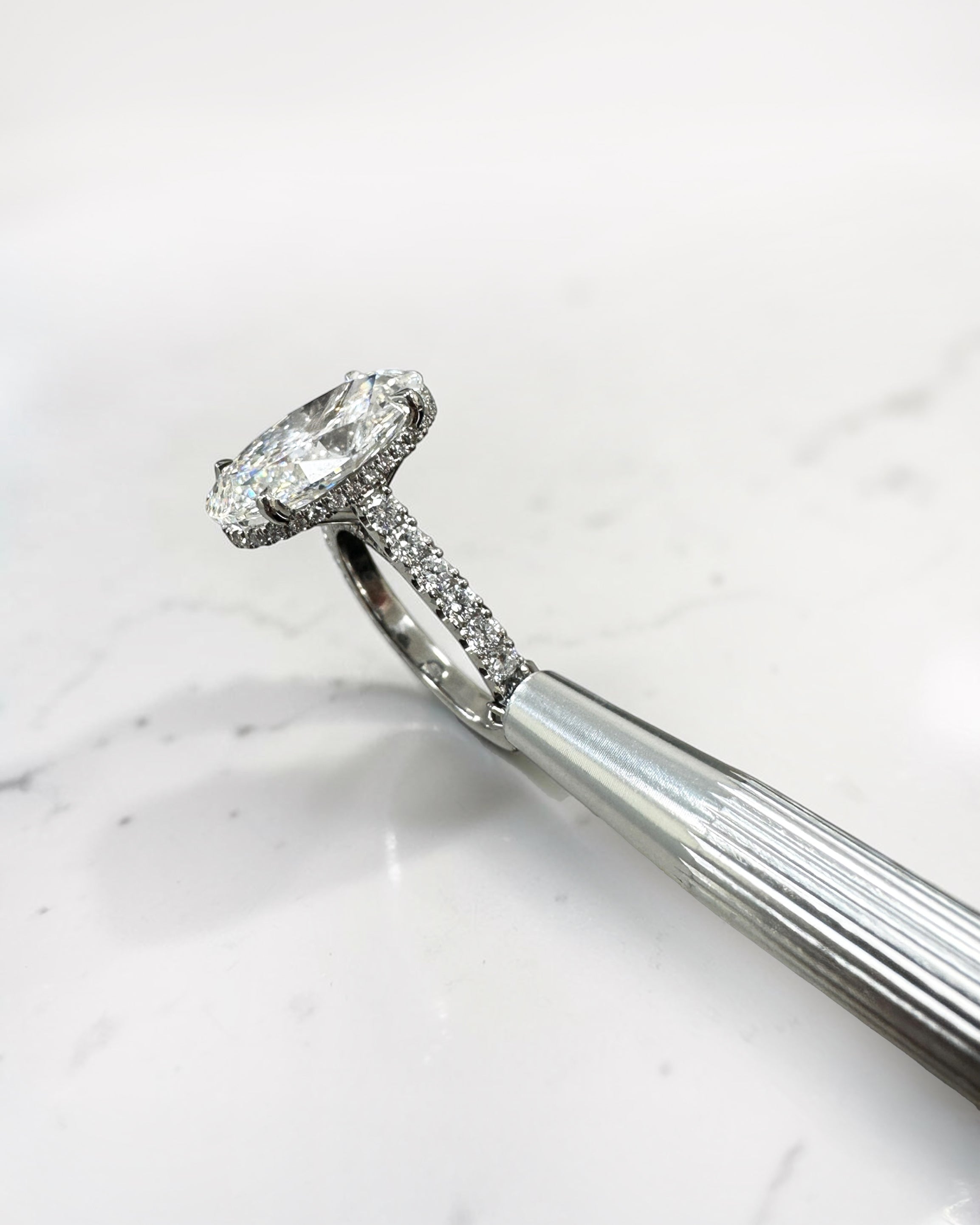 6ct oval cut lab grown diamond engagement ring with cathedral setting, diamond shoulder scallop band, diamond wrap hidden halo and diamond bridge. Handmade in London and available in platinum, 18ct yellow gold, white gold or rose gold.
