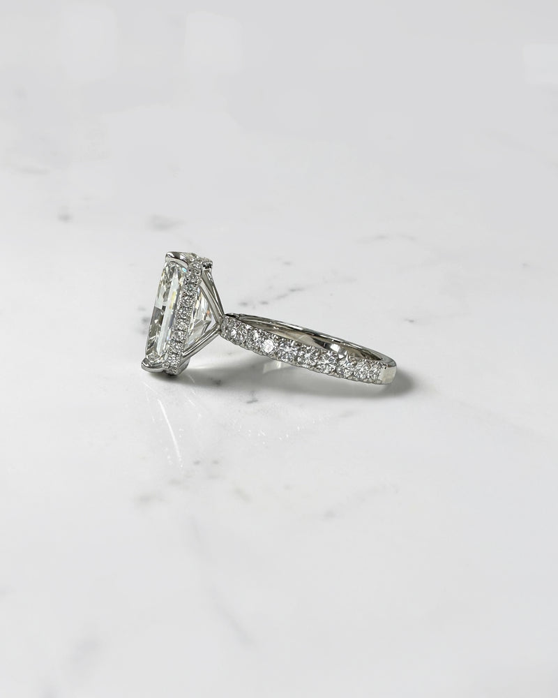 7ct radiant cut lab grown diamond engagement ring with diamond shoulder band, floating setting and wrap around hidden halo, handmade in London.