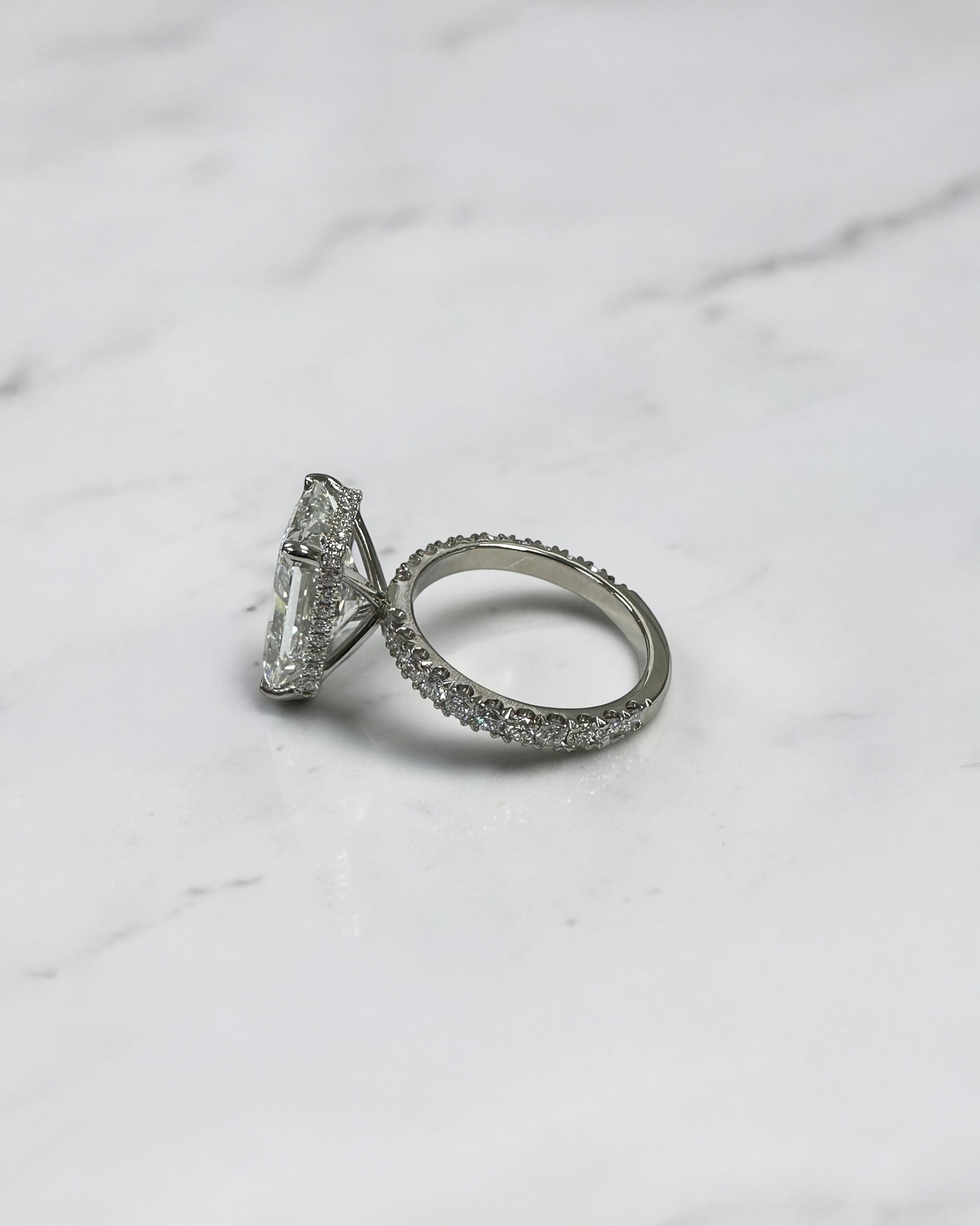 7ct radiant cut lab grown diamond engagement ring with diamond shoulder band, floating setting and wrap around hidden halo, handmade in London.