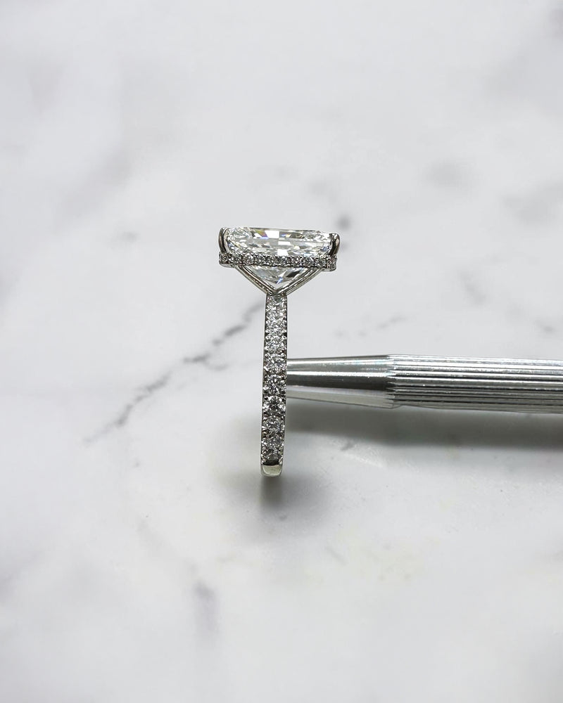 7ct radiant cut lab grown diamond engagement ring with diamond shoulder band, floating setting and wrap around hidden halo, handmade in London.