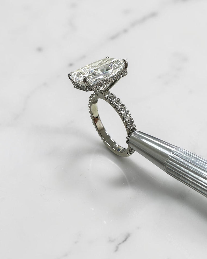 7ct radiant cut lab grown diamond engagement ring with diamond shoulder band, floating setting and wrap around hidden halo, handmade in London.