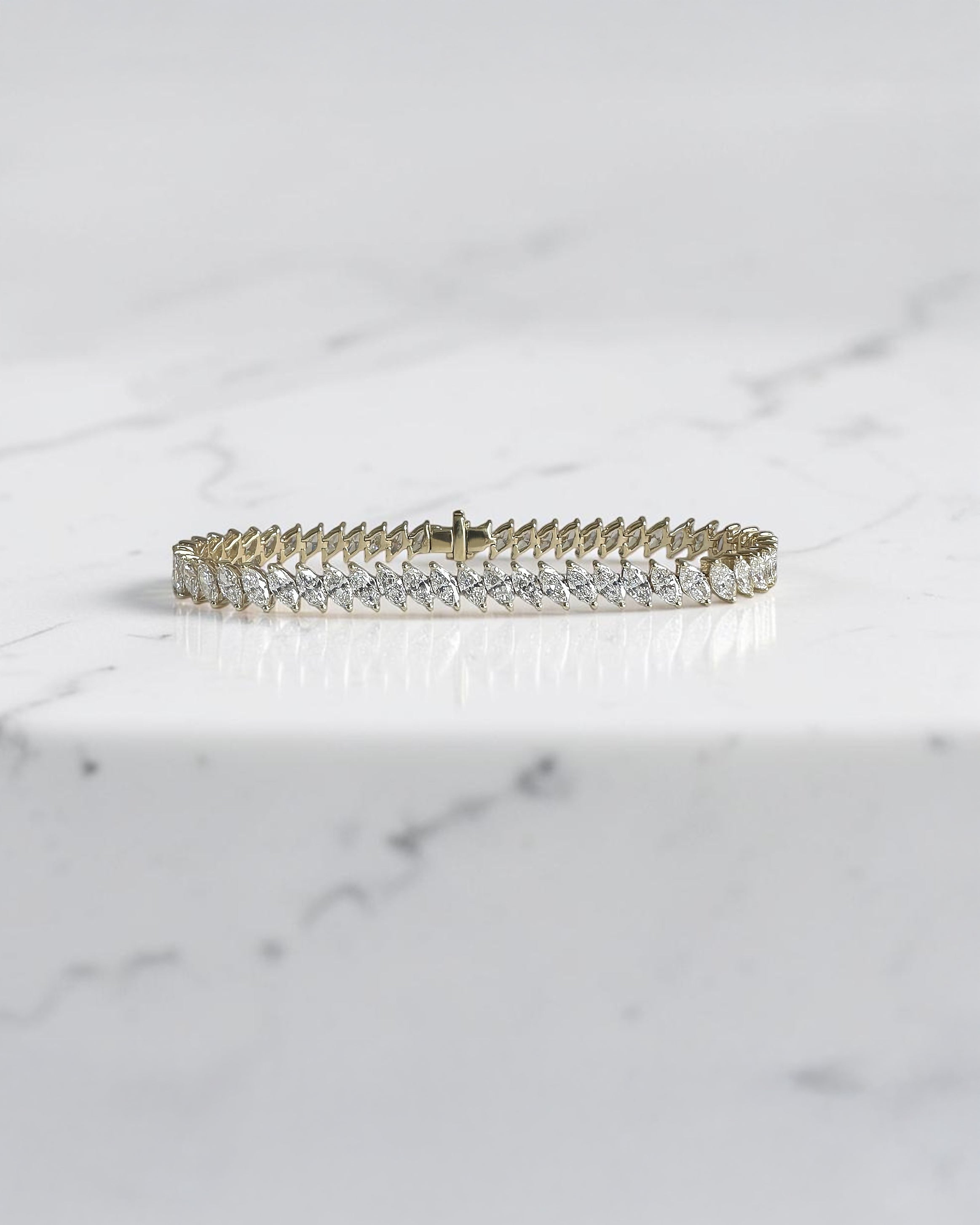 8ct+ slanted marquise cut diamond tennis bracelet in yellow gold with lab grown or natural diamonds.