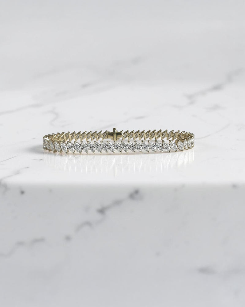 8ct+ slanted marquise cut diamond tennis bracelet in yellow gold with lab grown or natural diamonds.