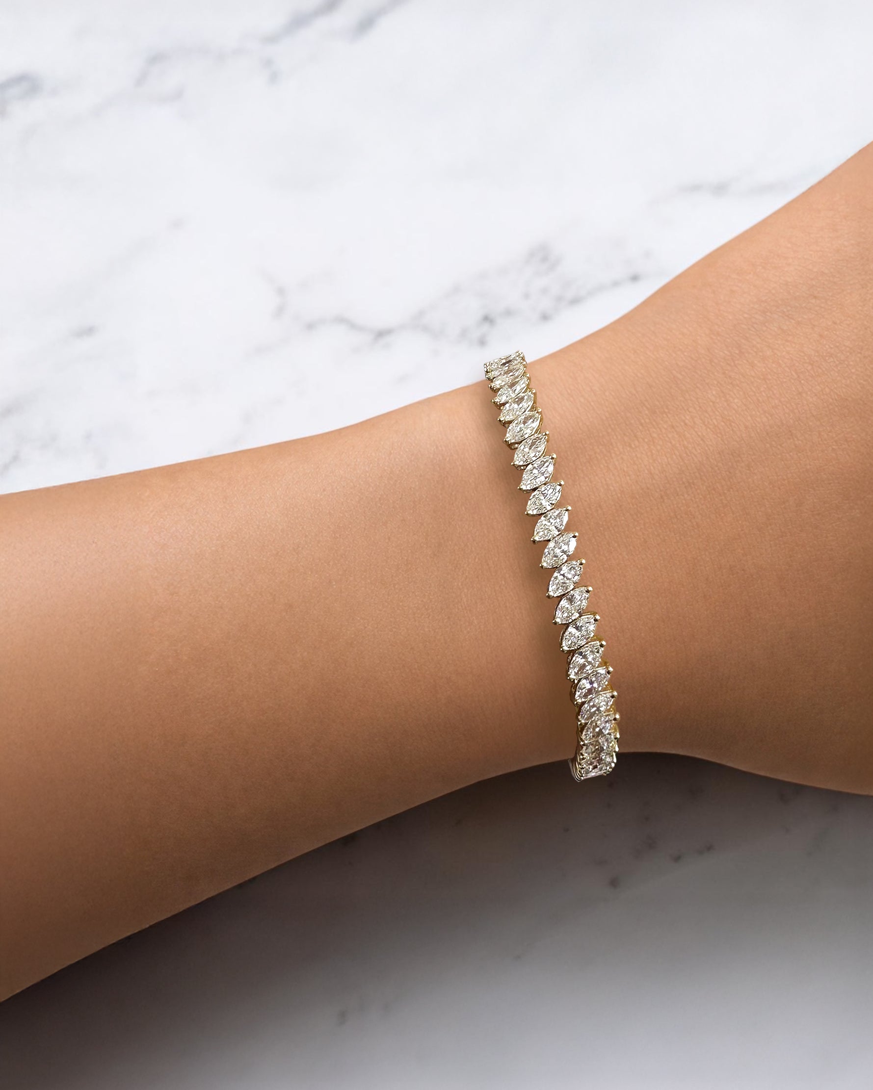 8ct+ slanted marquise cut diamond tennis bracelet in yellow gold with lab grown or natural diamonds.