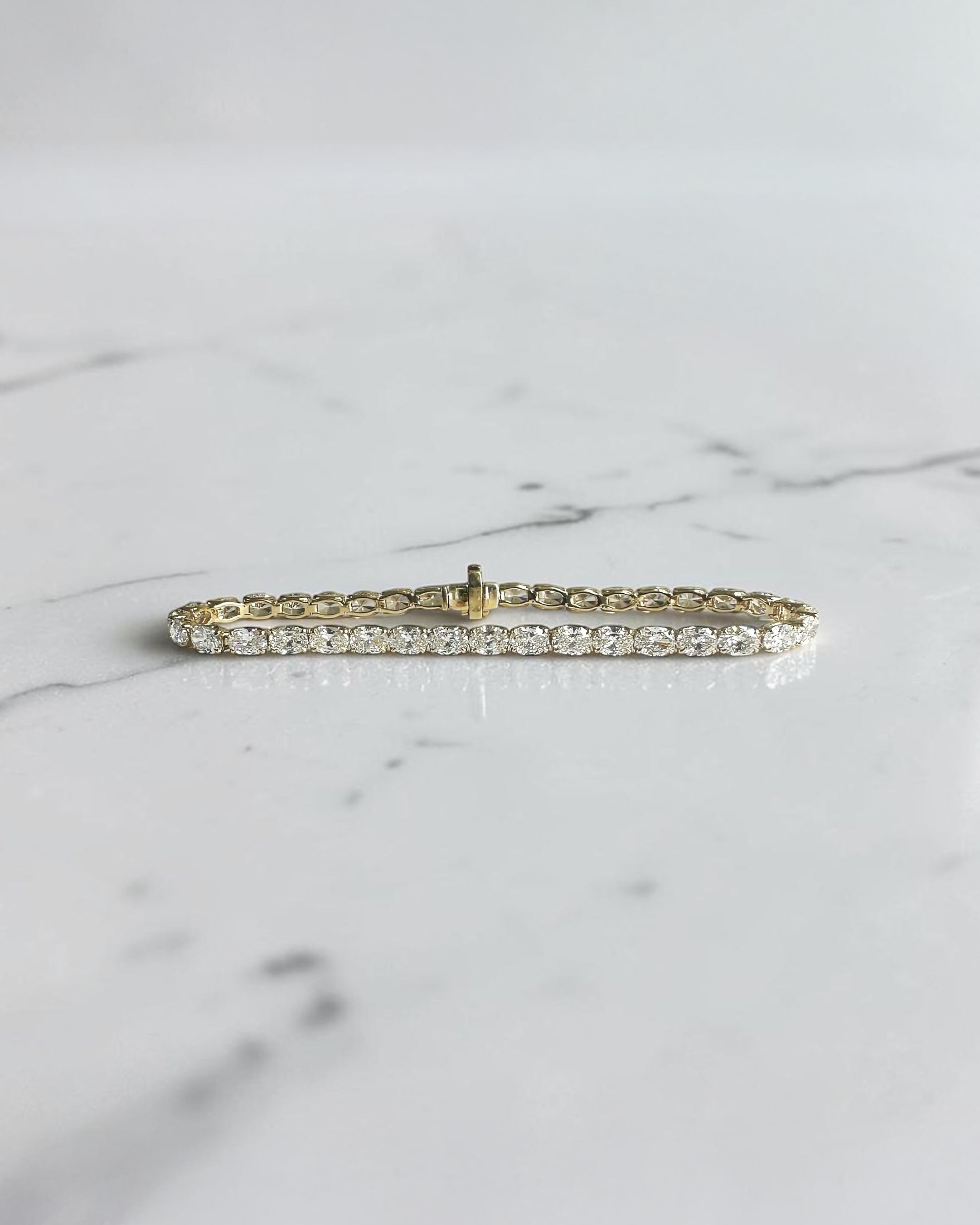 10ct oval cut diamond tennis bracelet in white gold featuring approximately 10 carats of oval diamonds with a 4.80mm width, available in lab grown or natural diamonds.