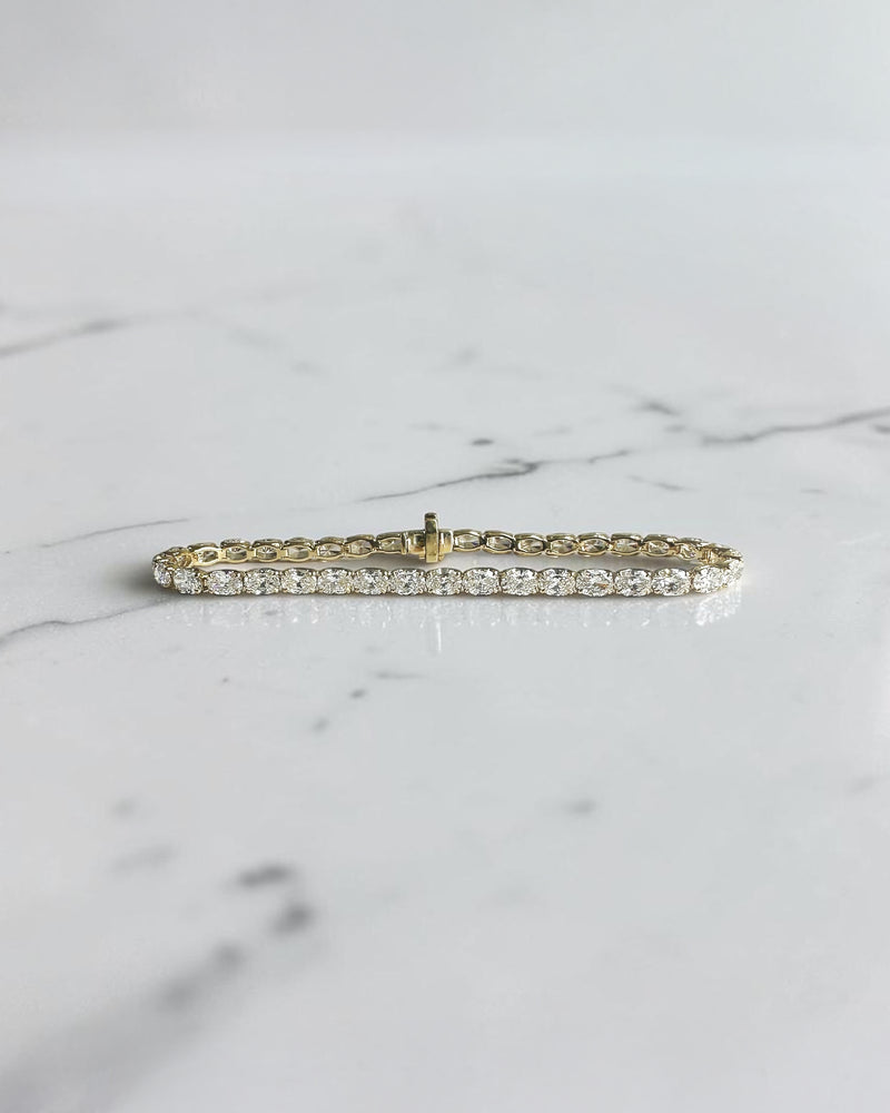 10ct oval cut diamond tennis bracelet in white gold featuring approximately 10 carats of oval diamonds with a 4.80mm width, available in lab grown or natural diamonds.