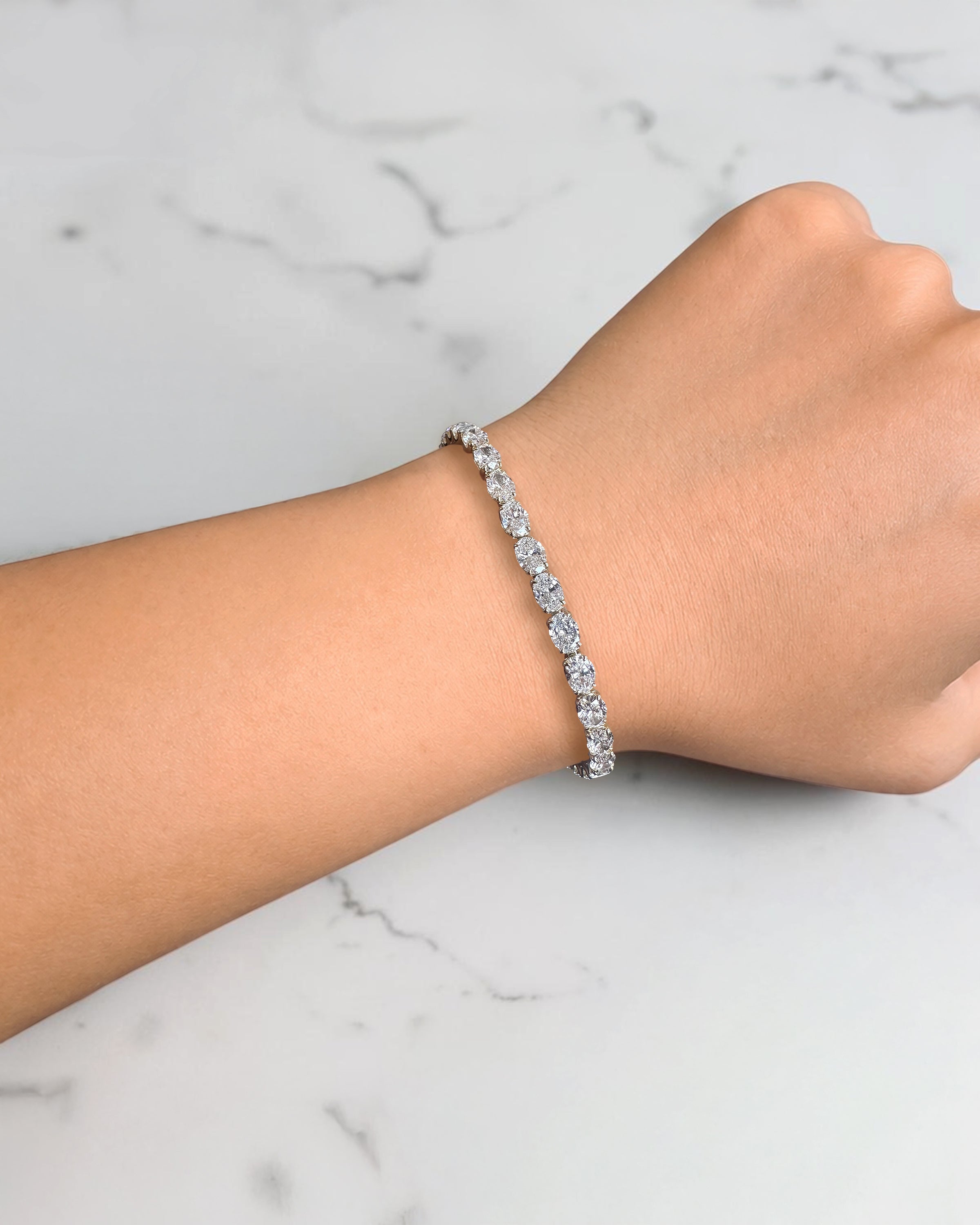 10ct oval cut diamond tennis bracelet in white gold featuring approximately 10 carats of oval diamonds with a 4.80mm width, available in lab grown or natural diamonds.