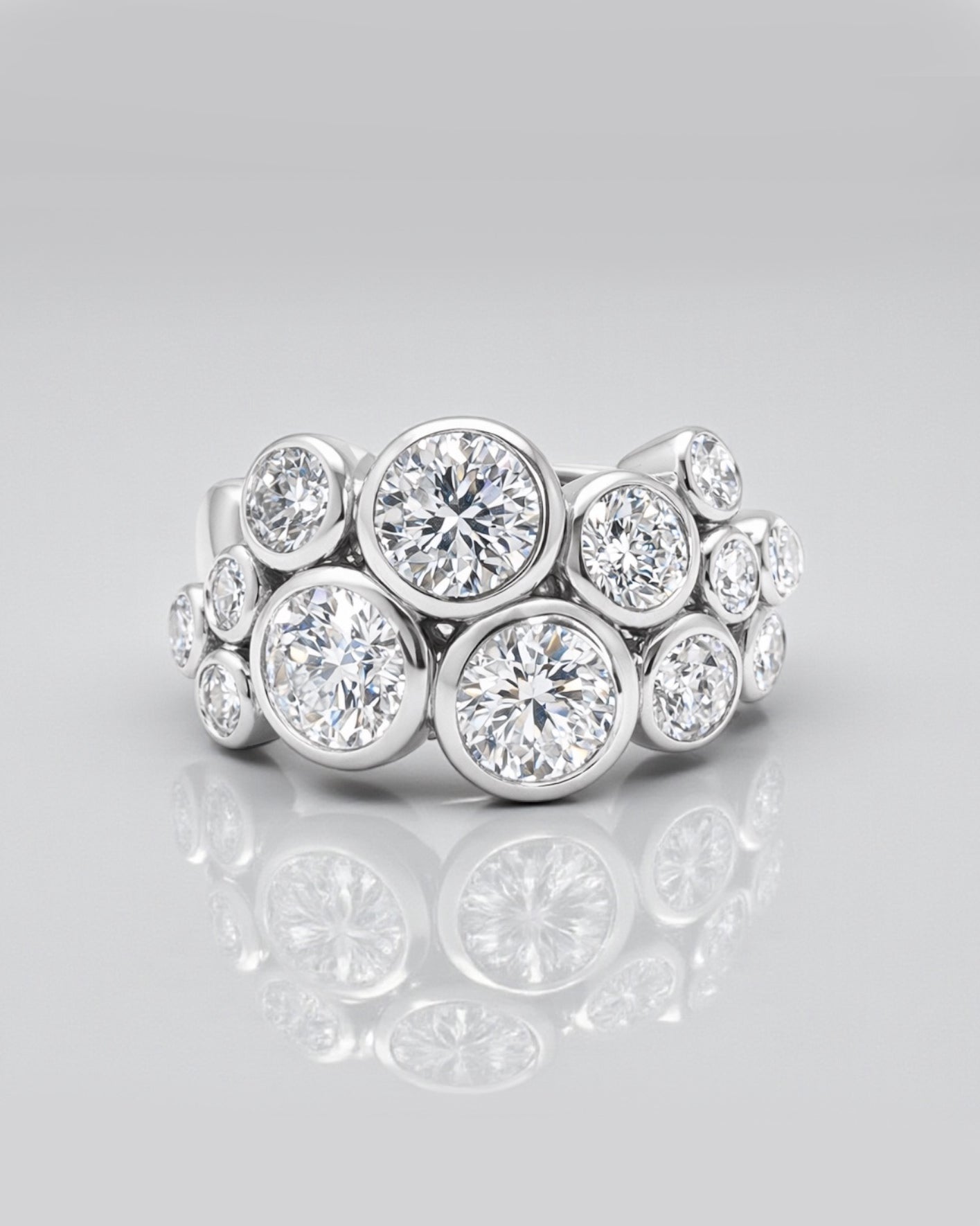 Bubble diamond ring with bezel set round diamonds, front view showing clustered bubble design. 9kt or 18kt yellow or white gold