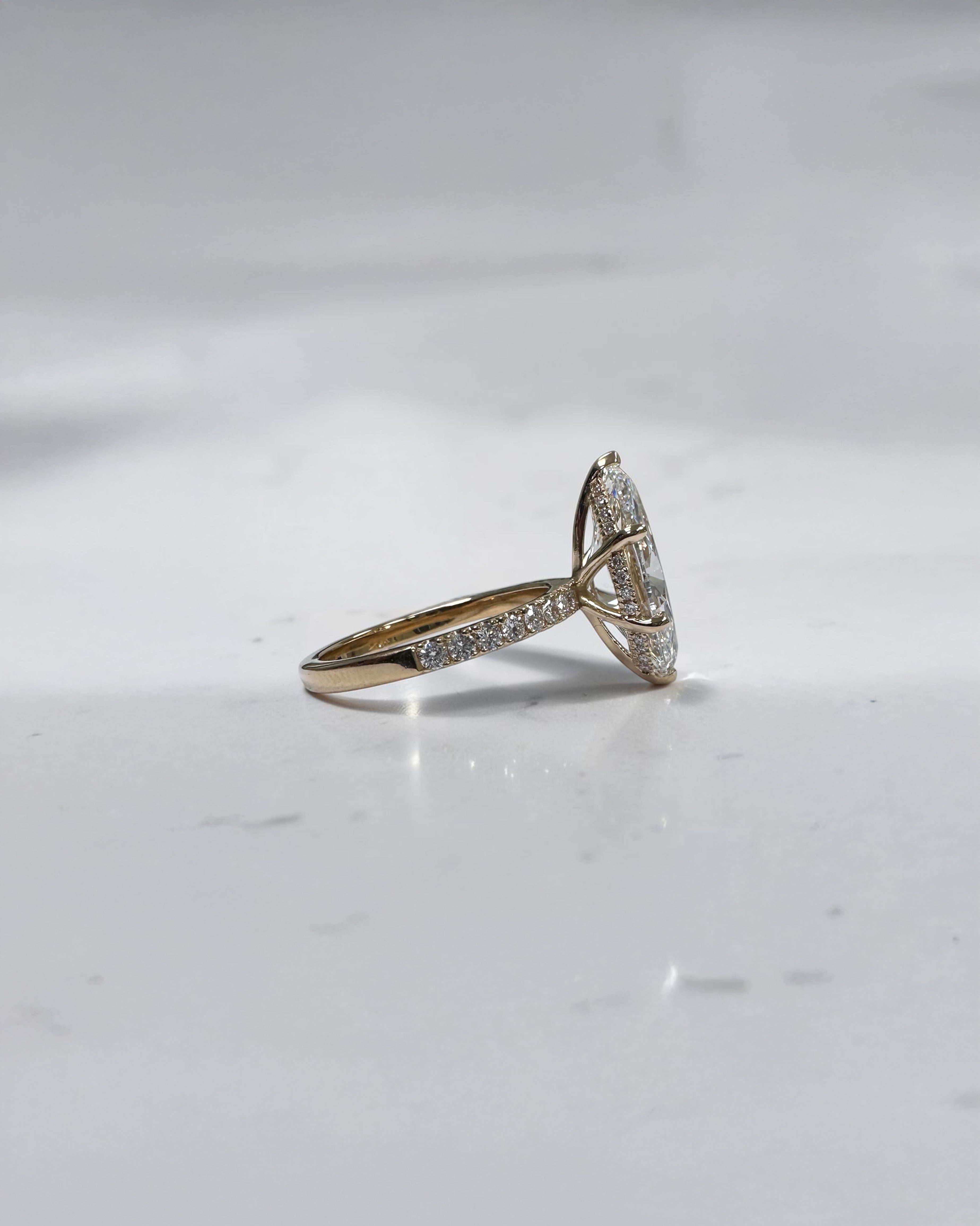 5ct marquise cut lab grown diamond engagement ring with hidden halo and diamond shoulders in floating setting