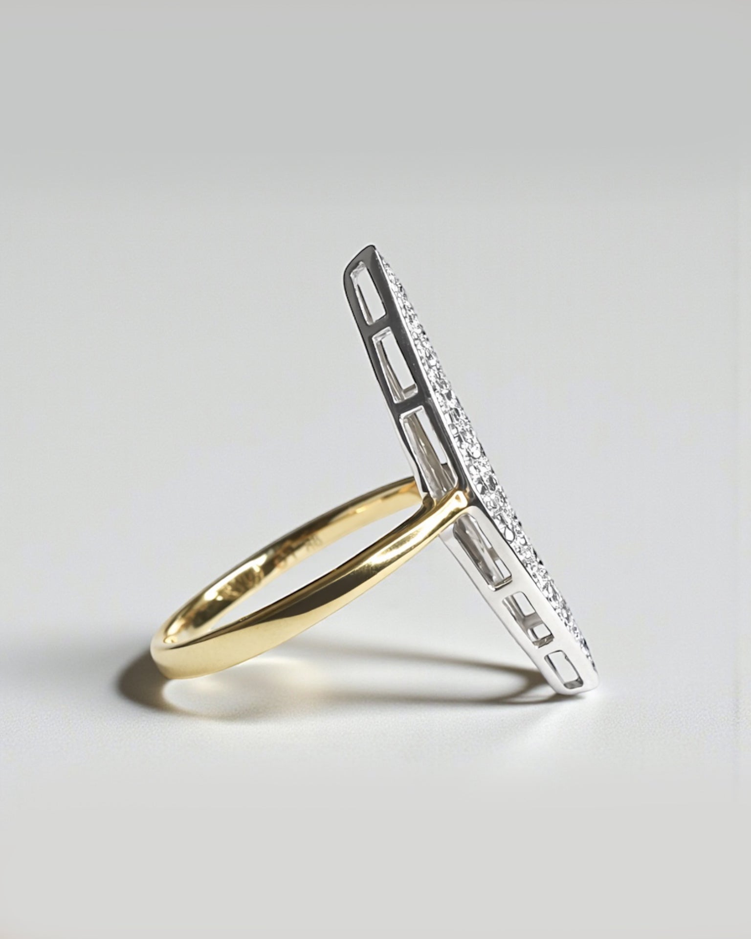 Side view of marquise cluster diamond ring showing white gold head and yellow gold band.