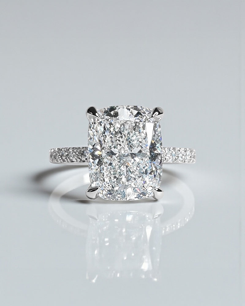 4ct cushion cut lab grown diamond engagement ring with diamond shoulders and hidden halo. Available in 18ct white, yellow, rose gold or platinum.
