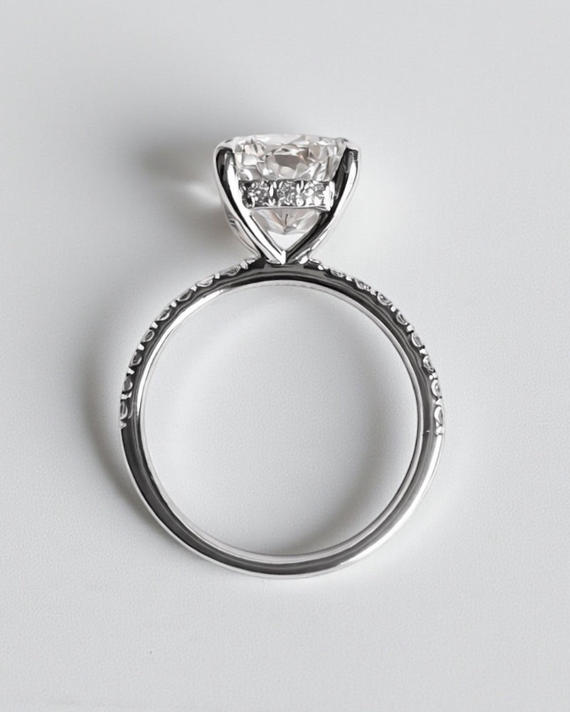 4ct cushion cut lab grown diamond engagement ring with diamond shoulders and hidden halo. Available in 18ct white, yellow, rose gold or platinum.