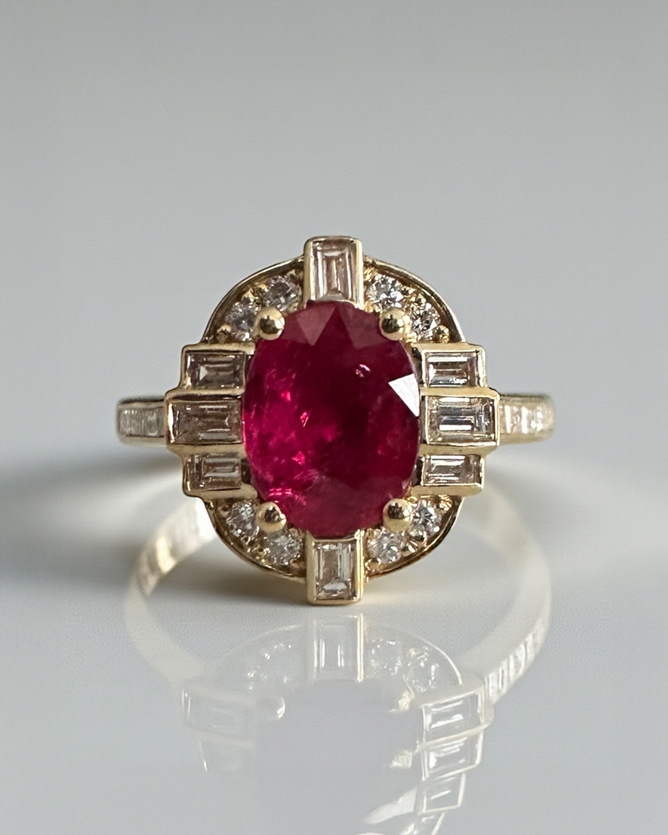 Vintage geometric style natural Ruby oval cut and mined diamond halo engagement ring, 18kt yellow gold