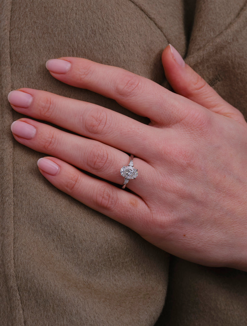 2ct oval cut lab grown diamond trilogy engagement ring with pear cut side diamonds by Layla Diamonds.