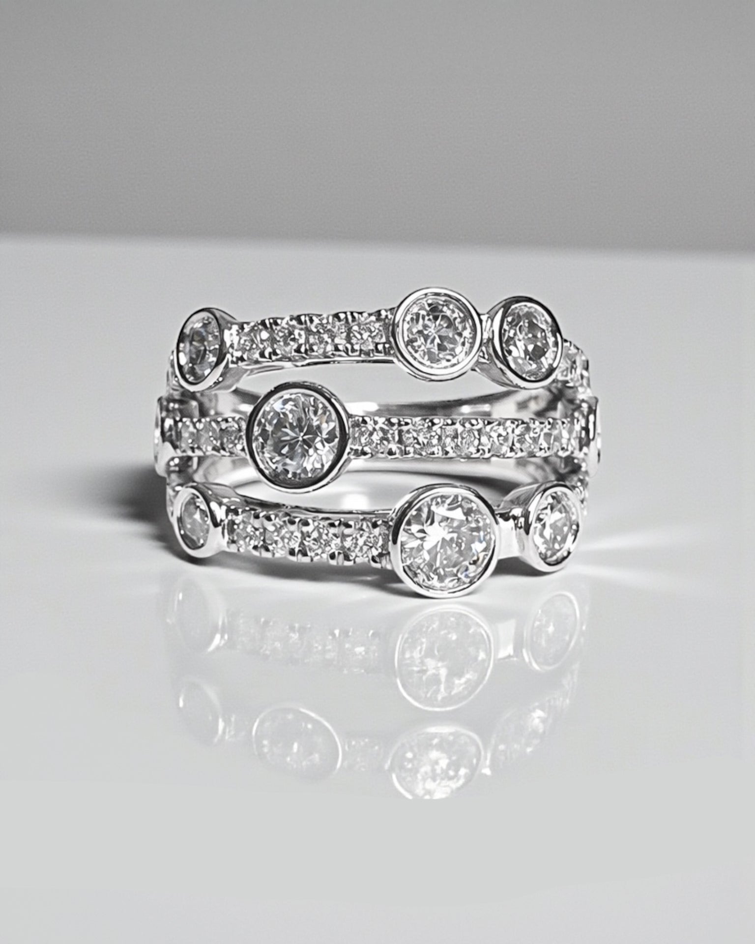 Bezel set bubble diamond dress ring with round diamonds in platinum or 18kt white gold