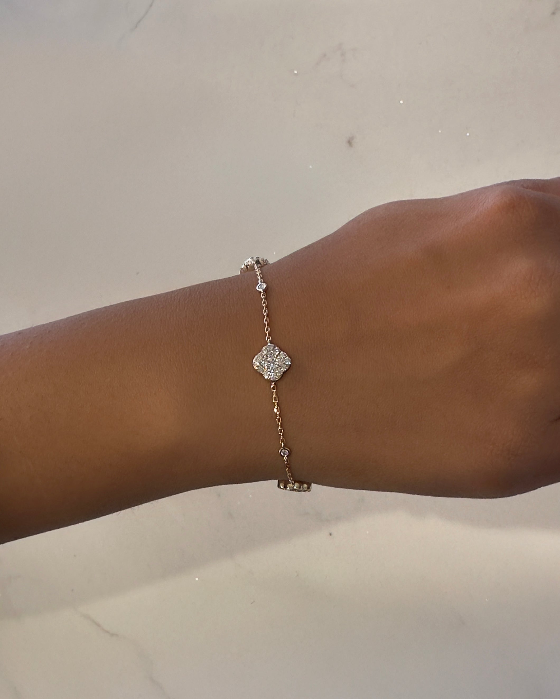 Diamond clover chain bracelet in platinum, yellow gold, rose gold, and white gold —  Layla Diamonds London on hand