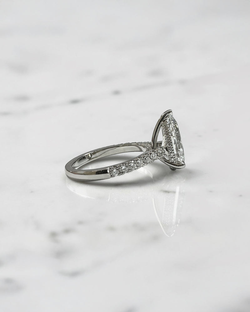 2ct pear cut lab grown diamond engagement ring with cathedral setting, diamond shoulder band, hidden halo and diamond bridge, handcrafted in platinum by Layla Diamonds.