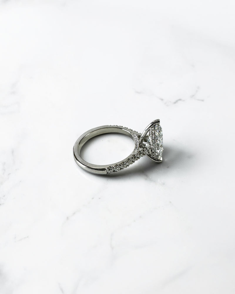 2ct pear cut lab grown diamond engagement ring with cathedral setting, diamond shoulder band, hidden halo and diamond bridge, handcrafted in platinum by Layla Diamonds.