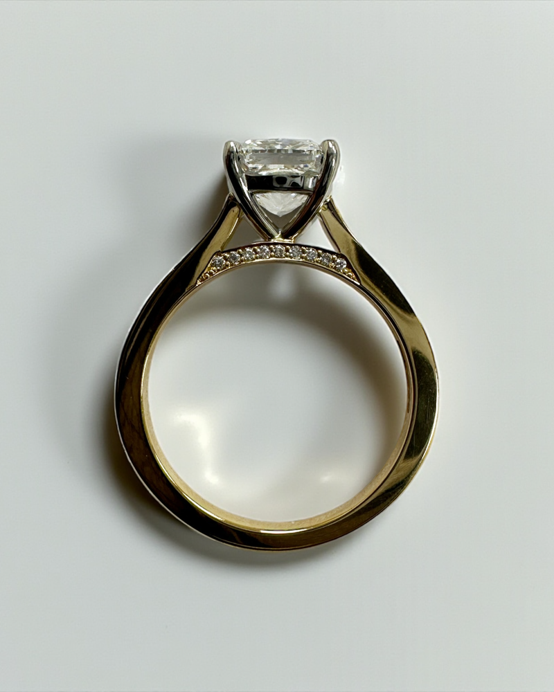Two tone cushion cut diamond engagement ring, featuring platinum head and channel set band 18kt yellow gold by Layla Diamonds
