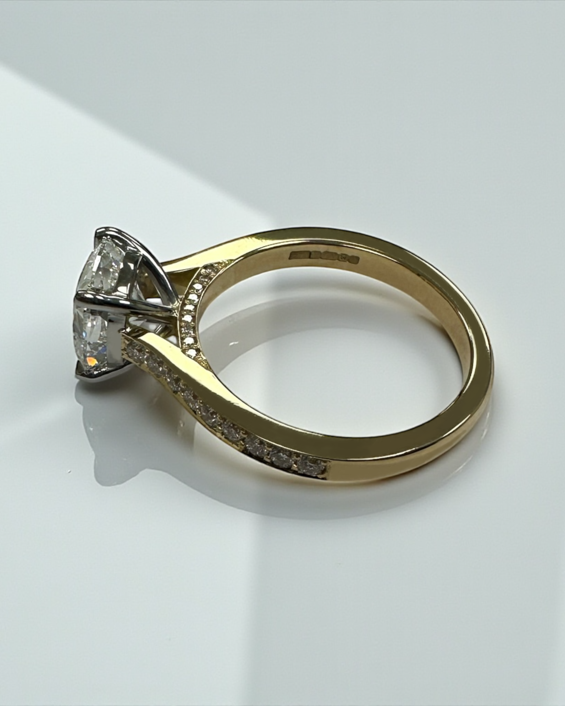 Two tone cushion cut diamond engagement ring, featuring platinum head and channel set band 18kt yellow gold by Layla Diamonds