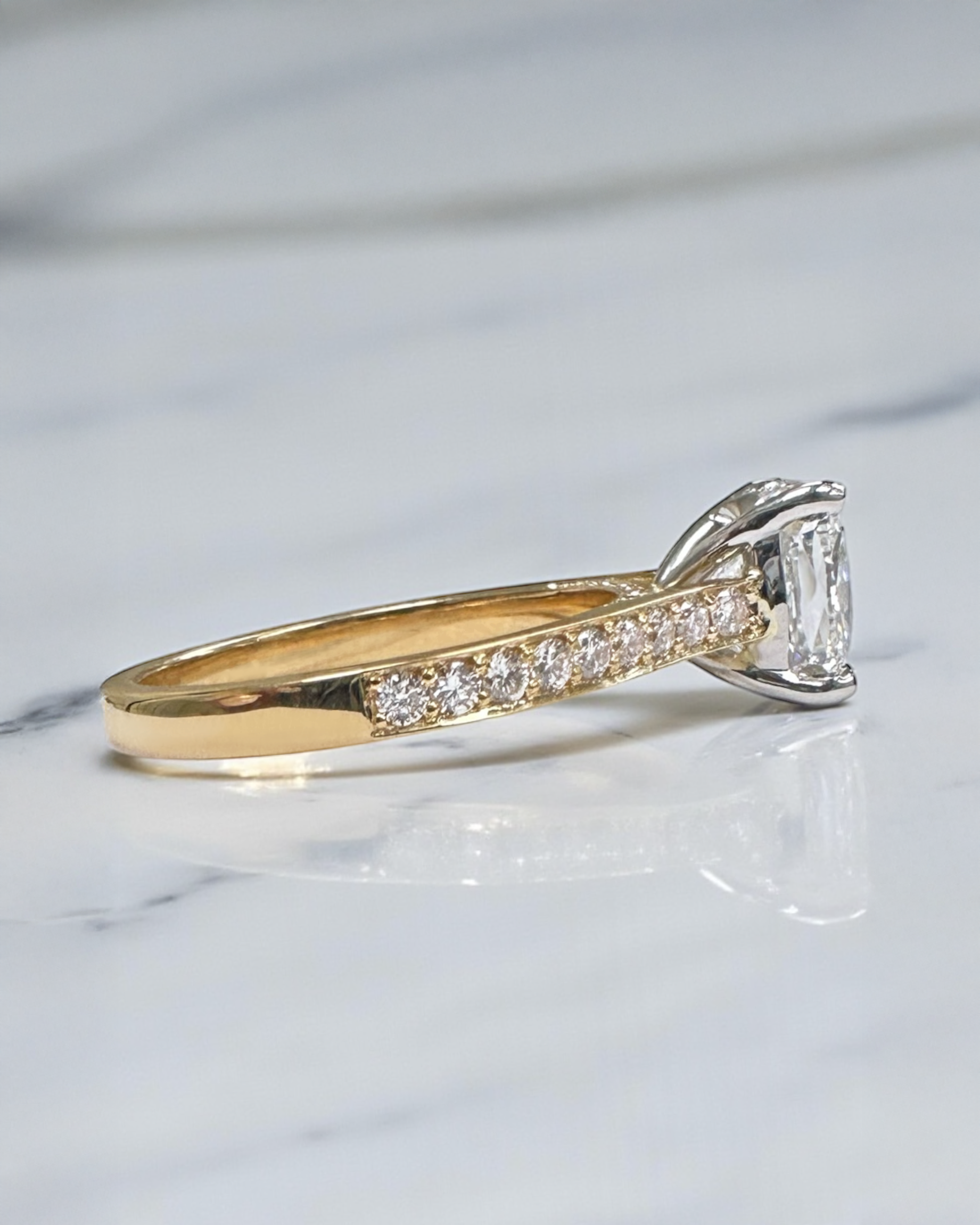 Two tone cushion cut diamond engagement ring, featuring platinum head and channel set band 18kt yellow gold by Layla Diamonds