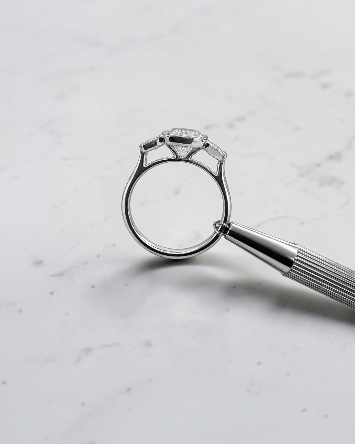 3ct elongated cushion cut lab grown diamond trilogy engagement ring with two 1ct side stones, bezel set rub over setting in polished white metal, handcrafted in London