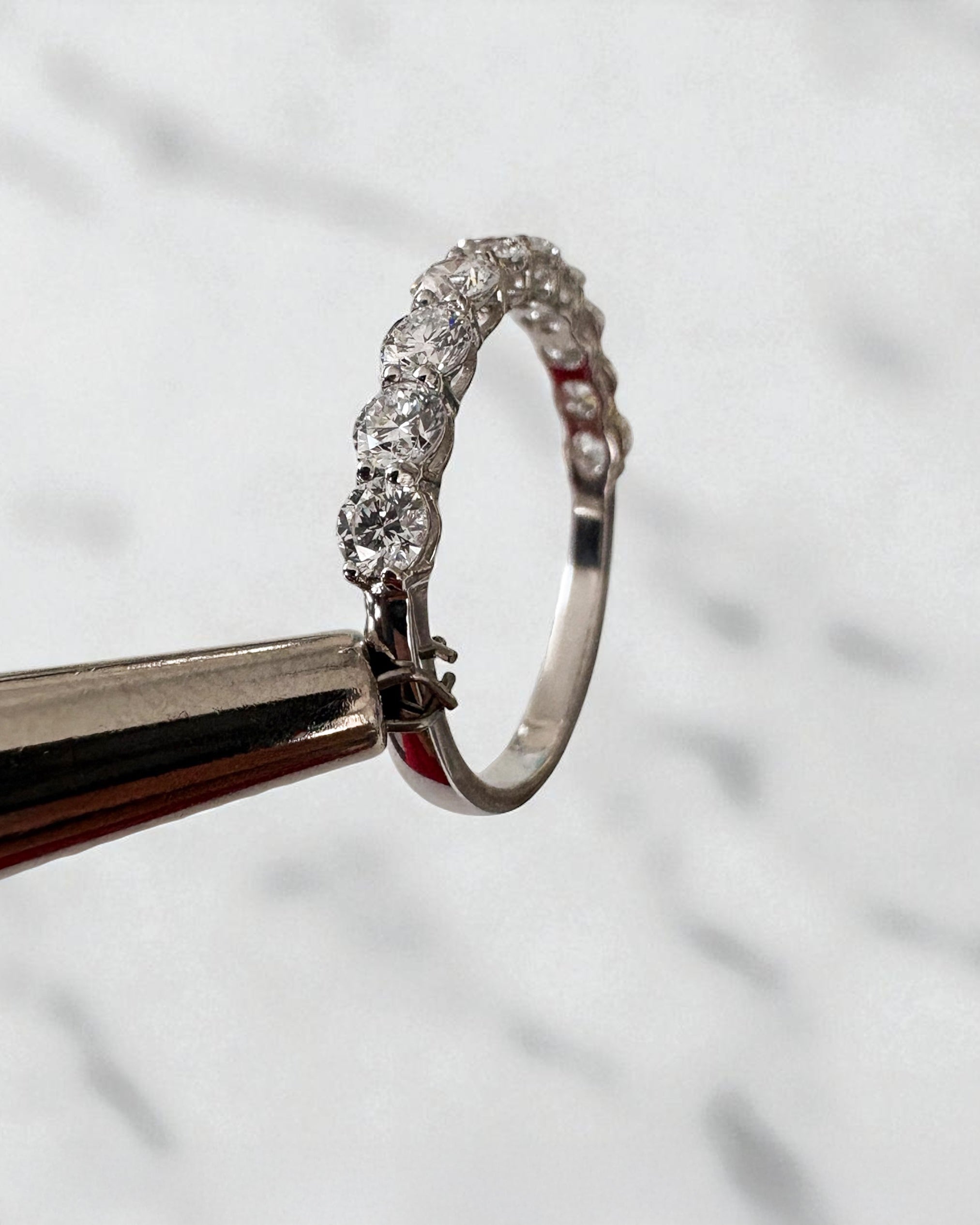 1ct round diamond half eternity band worn on a finger, showcasing a timeless diamond wedding bands design.