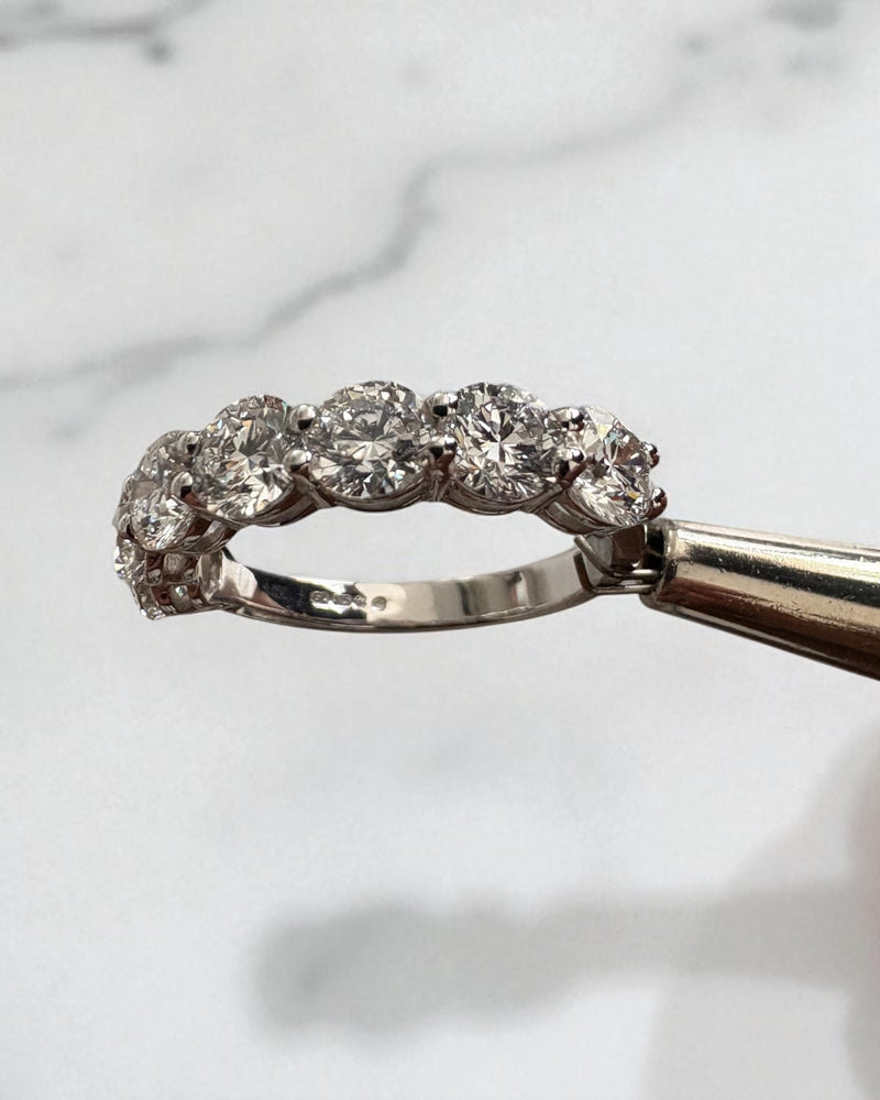 Close-up detail of the 2.50 carat round diamonds on this diamond wedding bands for women style.