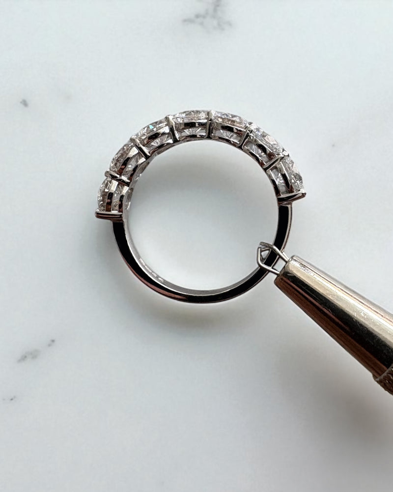 2.50ct round diamond half eternity band worn on a finger, showcasing a classic diamond wedding bands for women design.