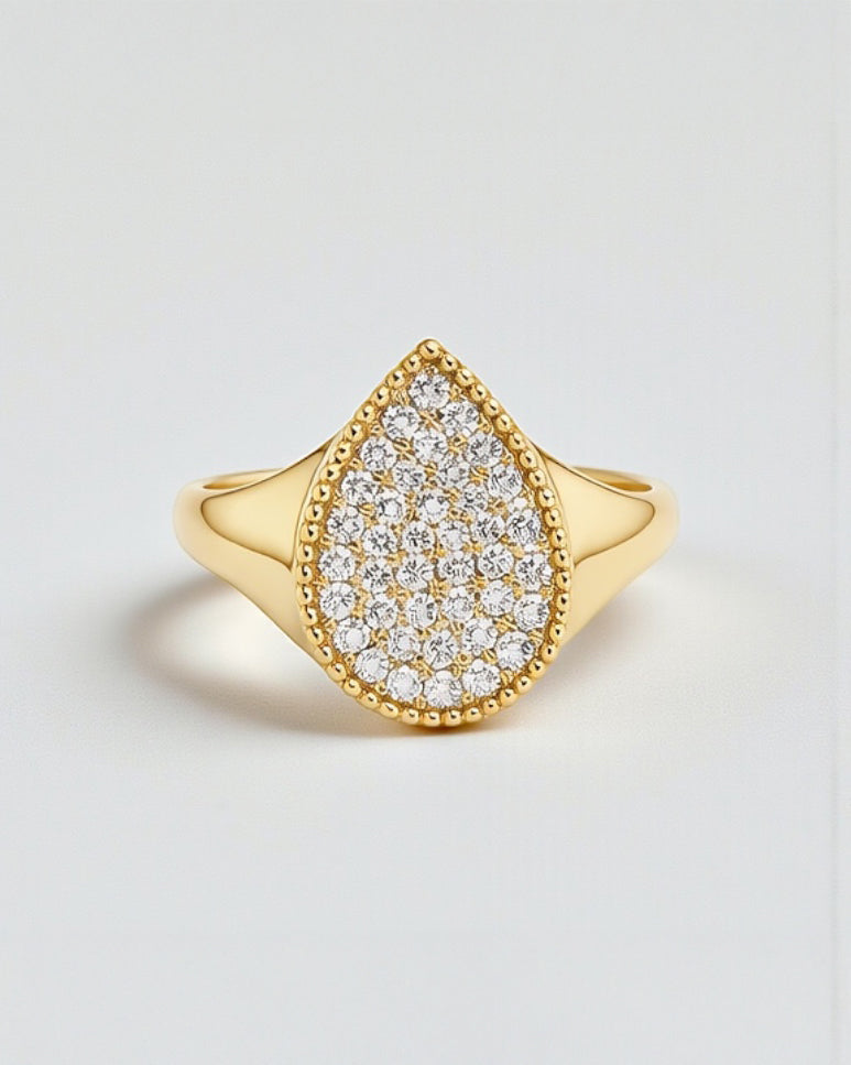 Pear drop diamond cluster signet ring in 9kt or 18kt yellow gold with pavé set diamonds, front view showing pear-shaped head.