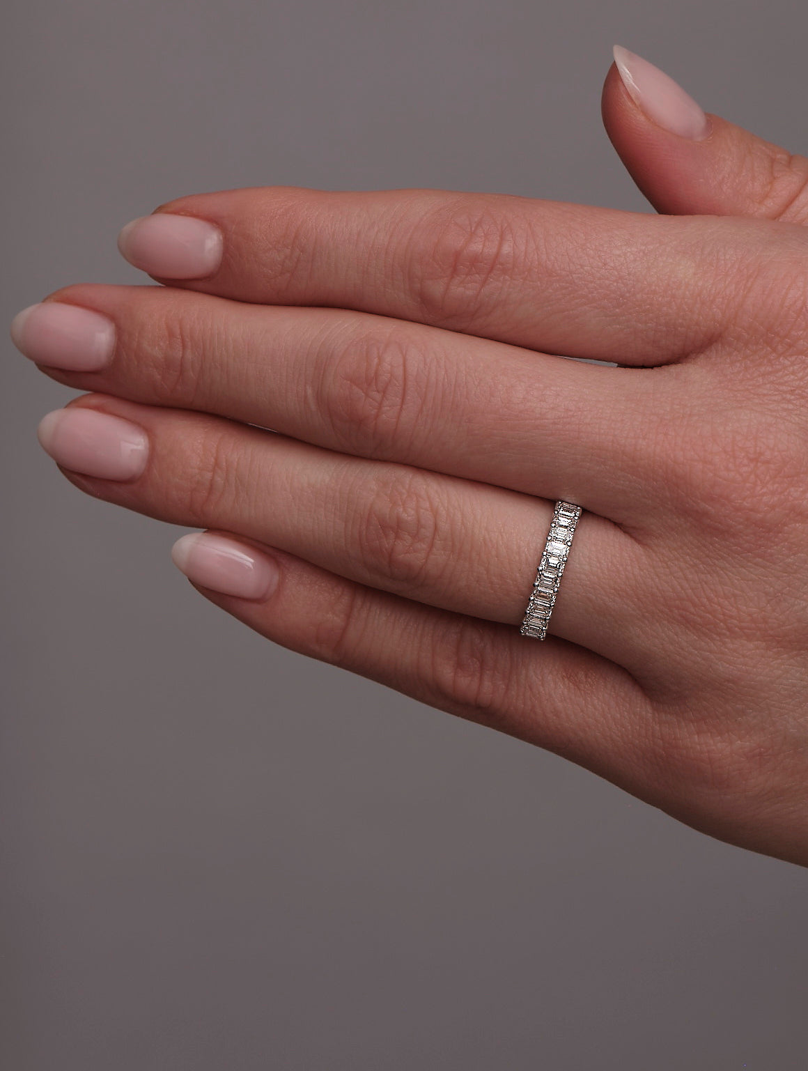 Side profile of the mini emerald cut diamond band, showcasing the clean step-cut profile.