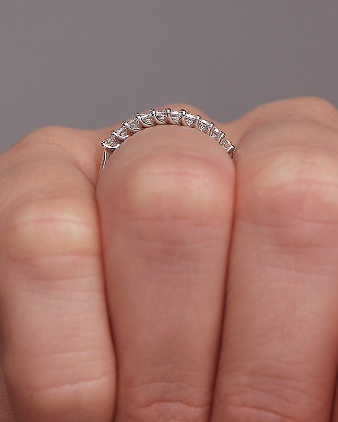 Perspective view of a luxury mini emerald cut diamond ring, perfect for pairing with other bridal sets.