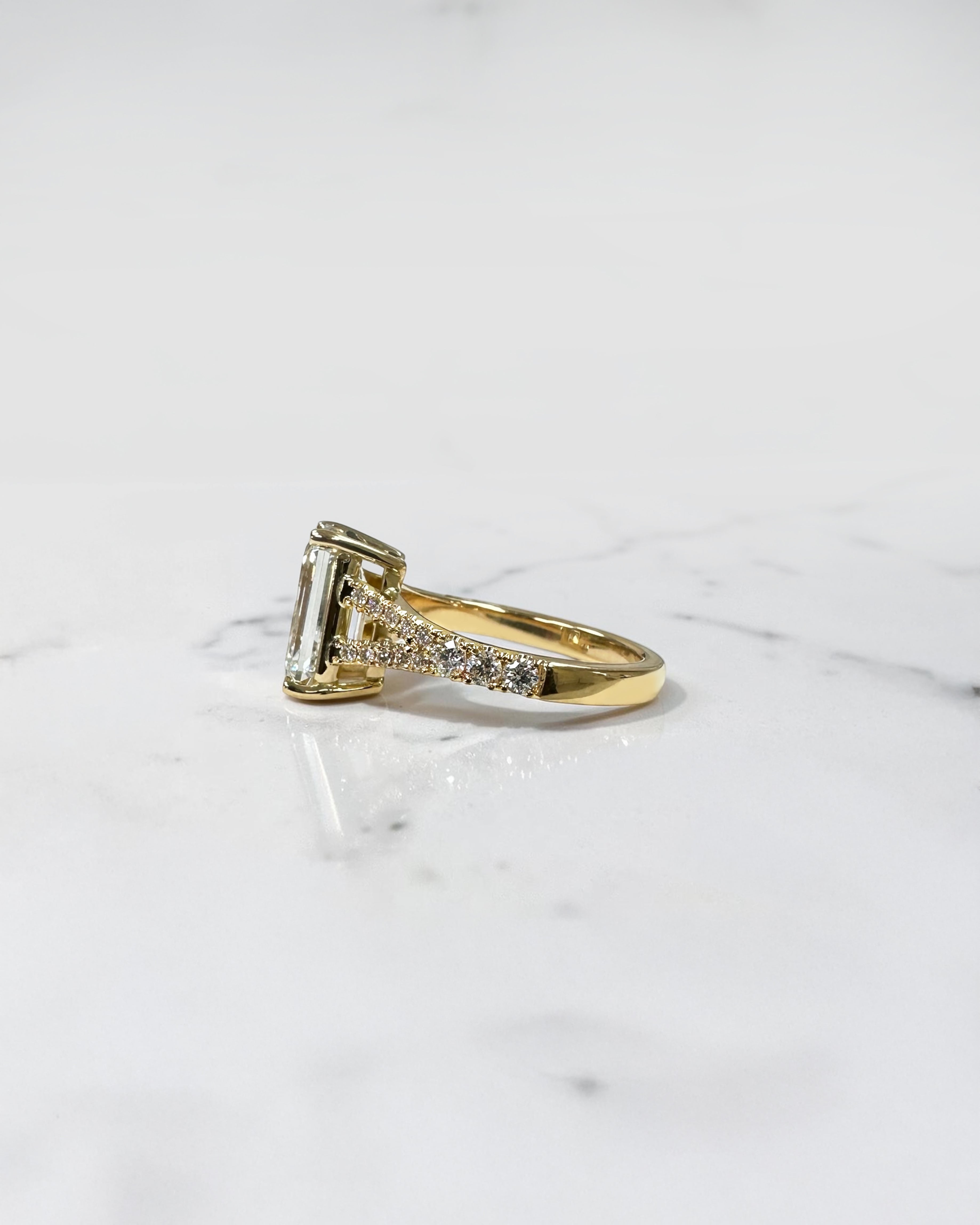 3ct emerald cut lab grown diamond engagement ring with a diamond split shank band, handcrafted in London and available in Platinum, 18ct yellow, white or rose gold.