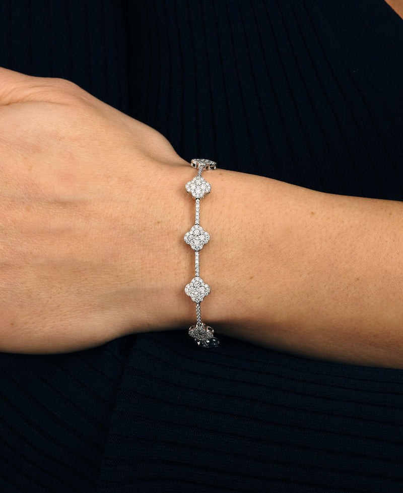 Diamond Clover Bracelet on wrist, 18kt white gold 3.90ct of brilliant diamonds in clover design, handcrafted luxury jewellery by Layla Diamonds London lab grown or natural mined diamonds on hand , wrist, arm