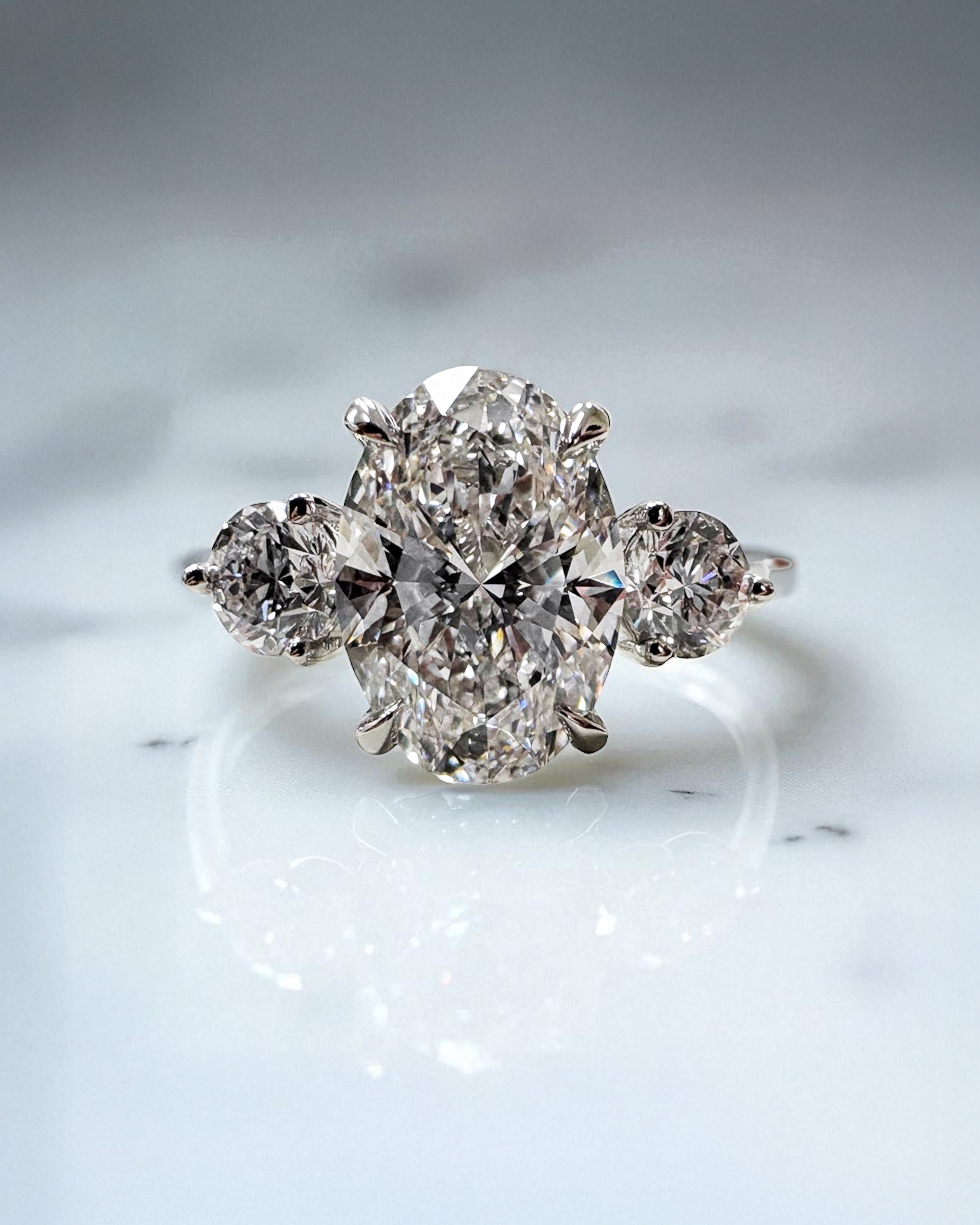 3.50ct lab grown oval cut diamond and round brilliant trilogy engagement ring