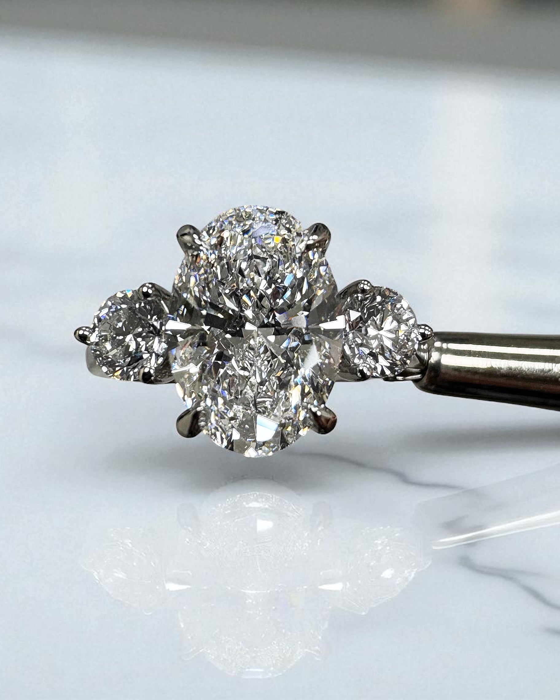 3.50ct lab grown oval cut diamond and round brilliant trilogy engagement ring