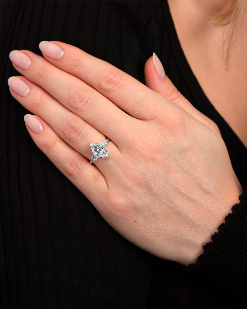 Detailed view of the setting of this marquise diamond and pear trilogy ring.