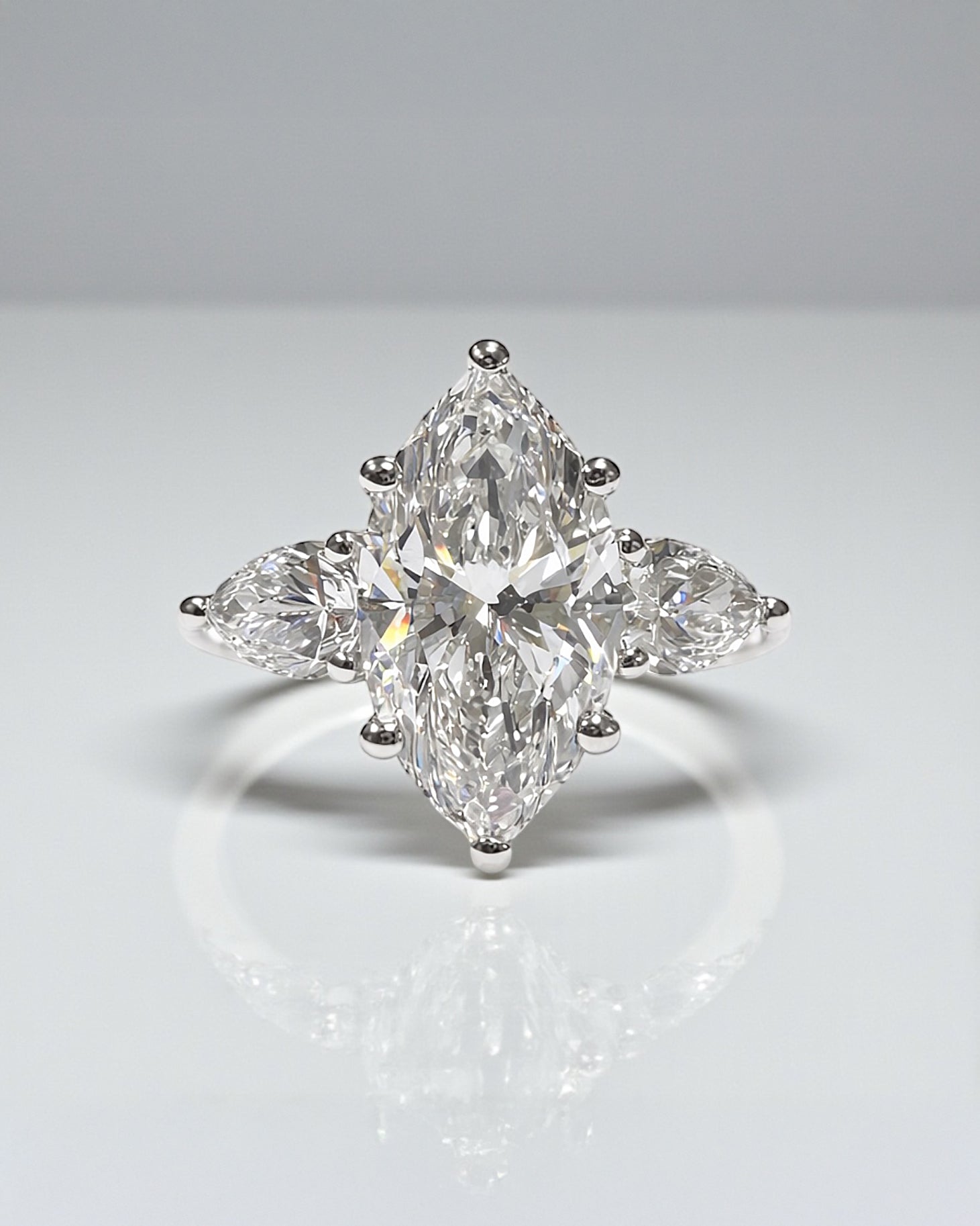A 3ct marquise diamond trilogy ring with pear shaped side stones.