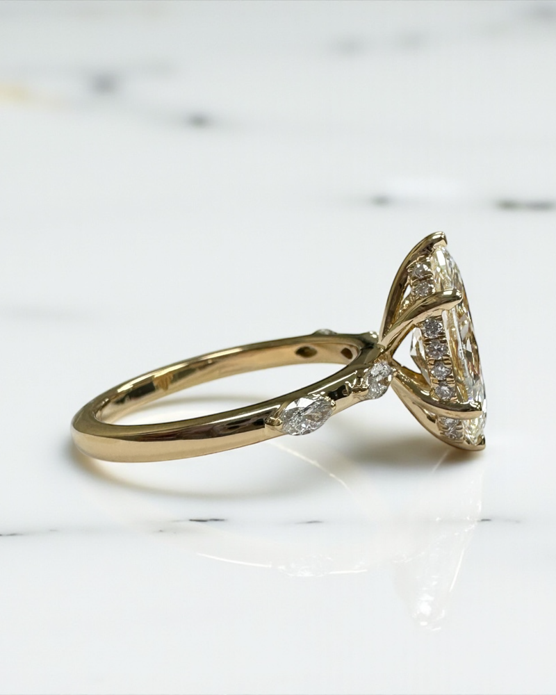 2ct marquise diamond ring with a marquise band worn on a finger.