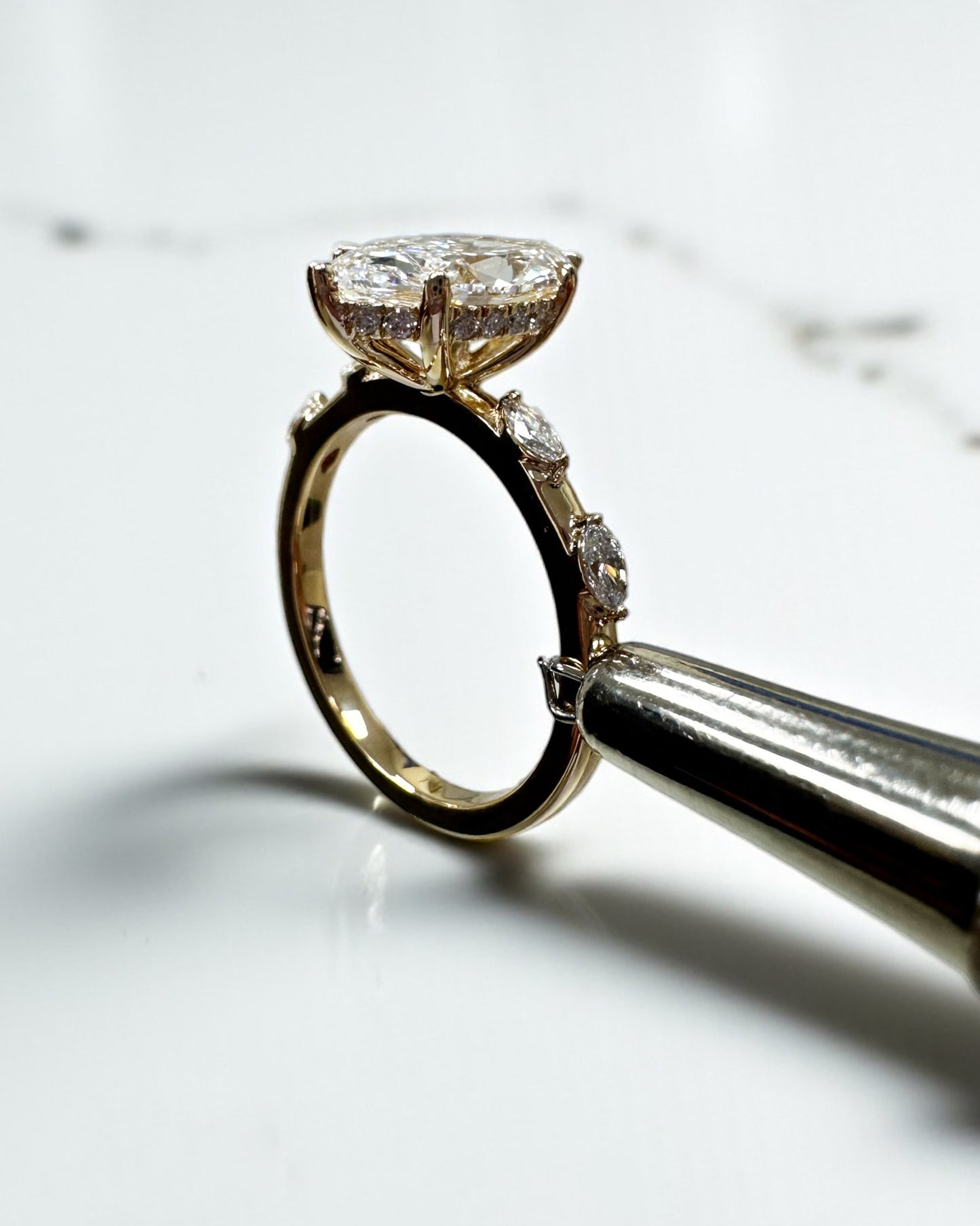 Side profile of a 2 carat marquise diamond ring and coordinating diamond band.